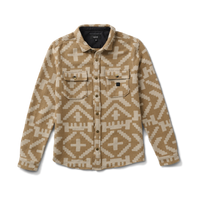 Adventurous traveler exploring a remote landscape with Roark gear, capturing the essence of exploration and freedom.