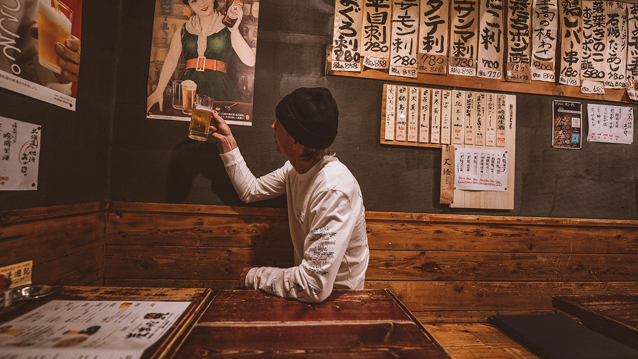 man_in_roark_drinking_in_hokkaido