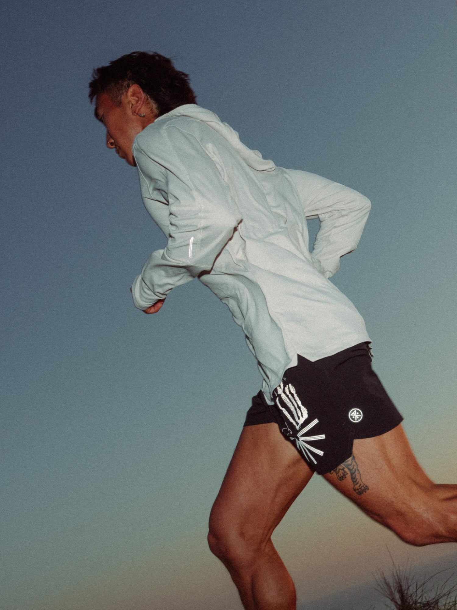 Person in sportswear featuring shorts and active sleeve, ready for an outdoor adventure showing knee flexibility, embodying Roark's spirit of adventure and travel.