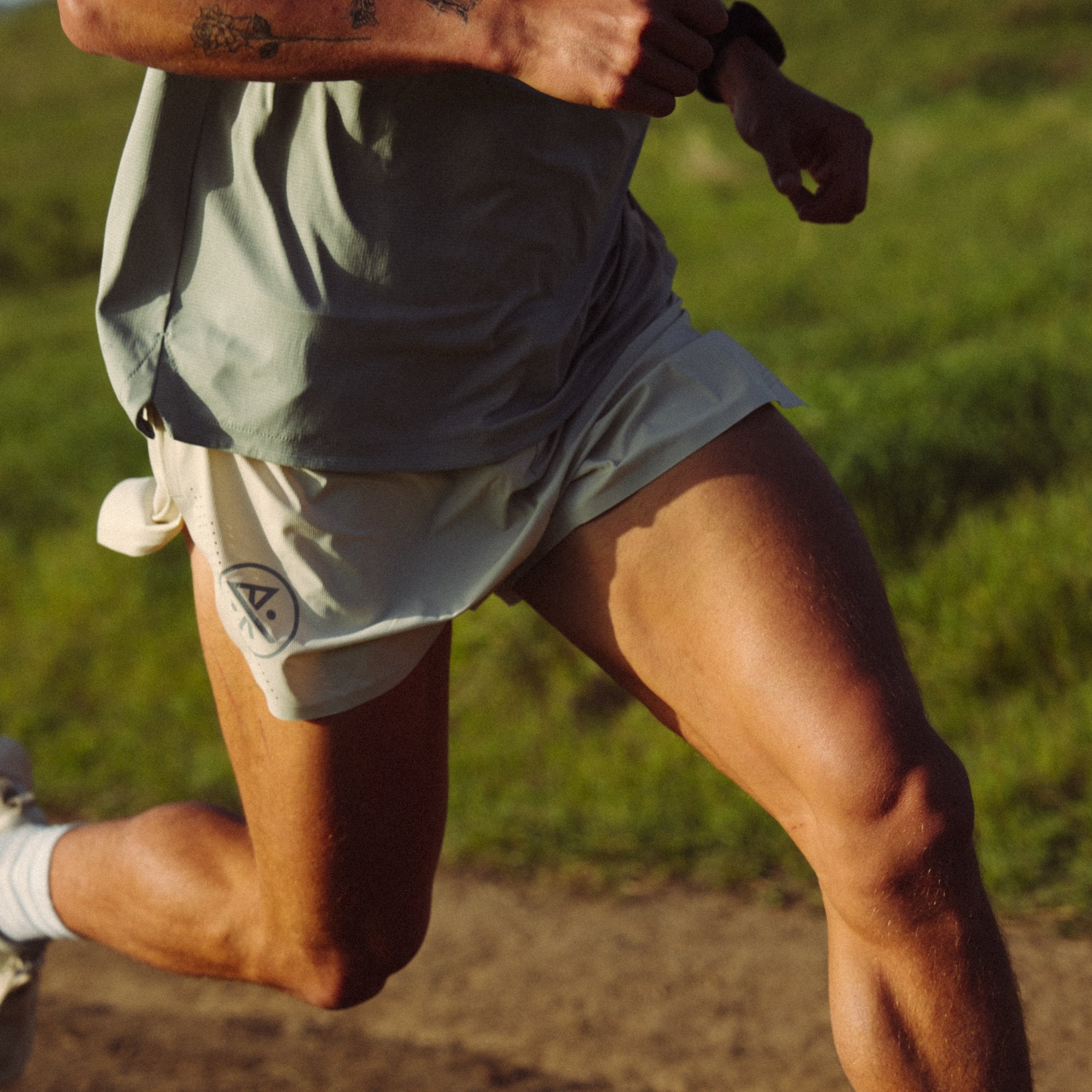 Model showcasing Roark Alta Elite 3.5 Shorts, focusing on fit and design ideal for adventure and travel, highlighting the thigh, knee, and calf areas for outdoor activities.