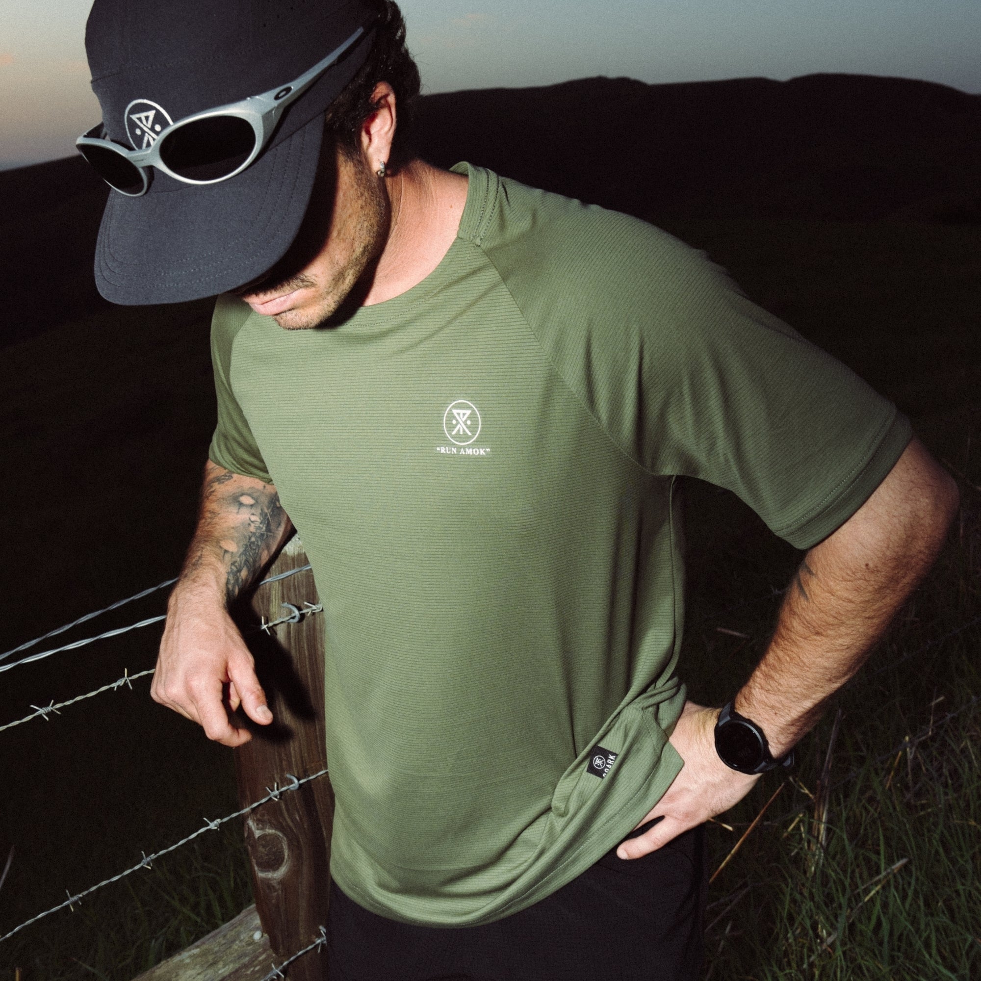 Active man wearing a Roark Alta Elite Trail Short Sleeve Tee and sporting a versatile cap, ready for outdoor adventures.
