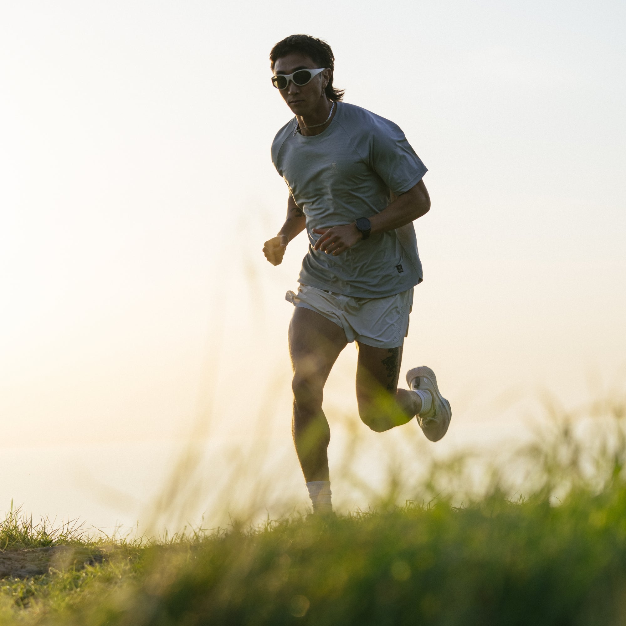Active person wearing shorts while running on a scenic trail, embodying adventure and outdoor exercise