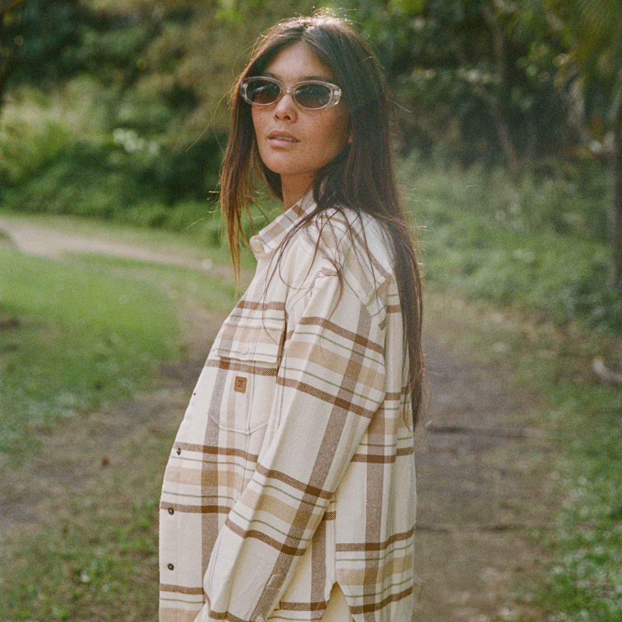Close-up detail of a Roark Amberley flannel shirt featuring a classic plaid tartan pattern, stylish collar, and visible buttons, perfect for adventure and travel.