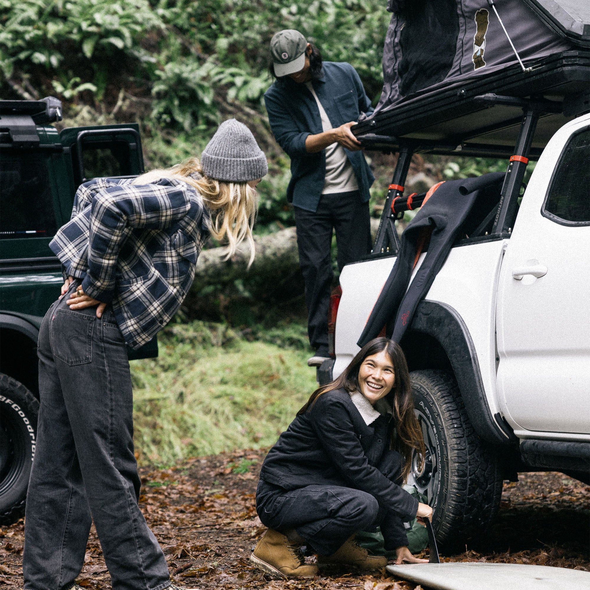Adventure-ready jacket displayed on a car with a roof rack, ready for travel in a rugged outdoor setting