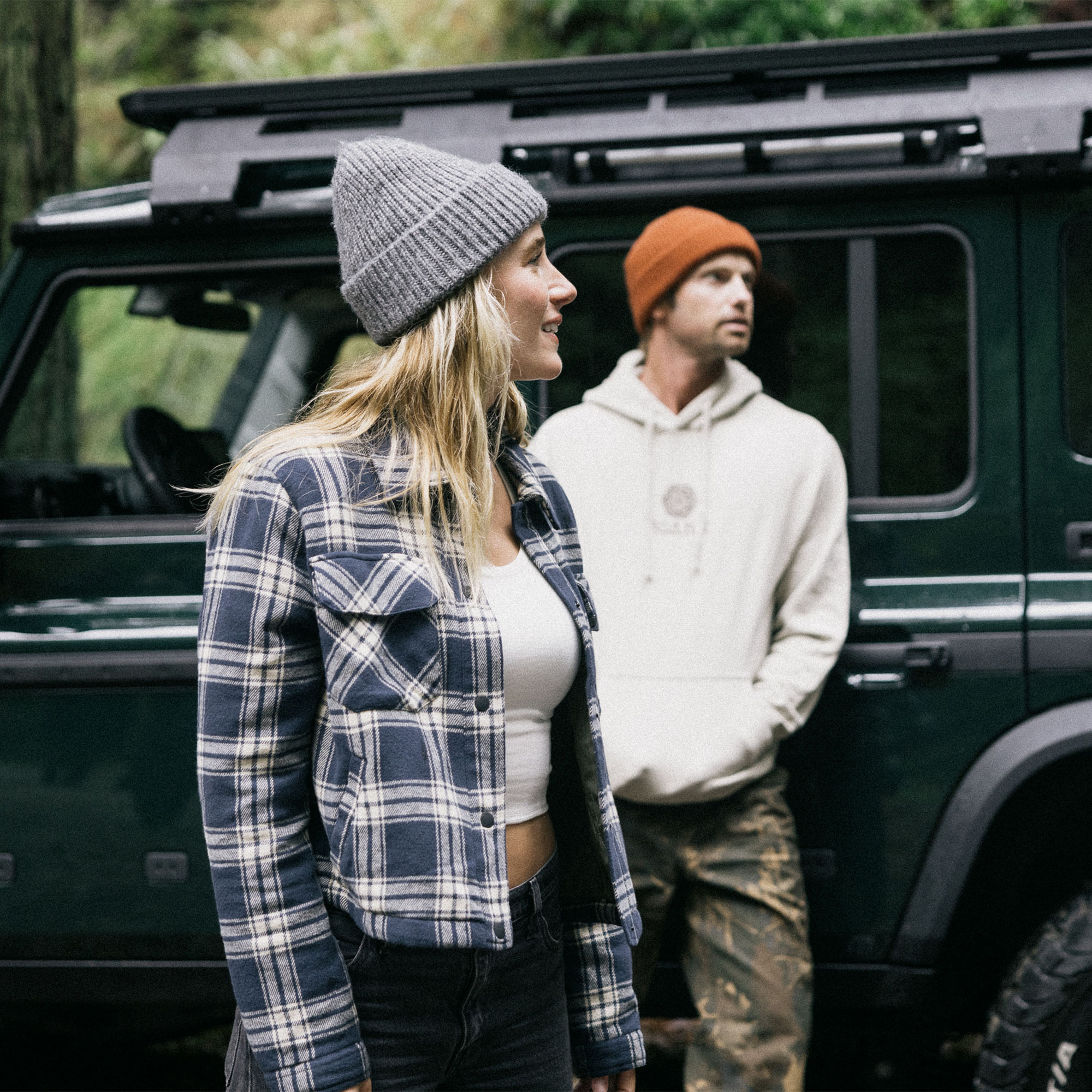 Outdoor enthusiast wearing a warm Backwoods jacket and knit cap in a winter setting, embodying Roark's adventurous and travel-ready style.