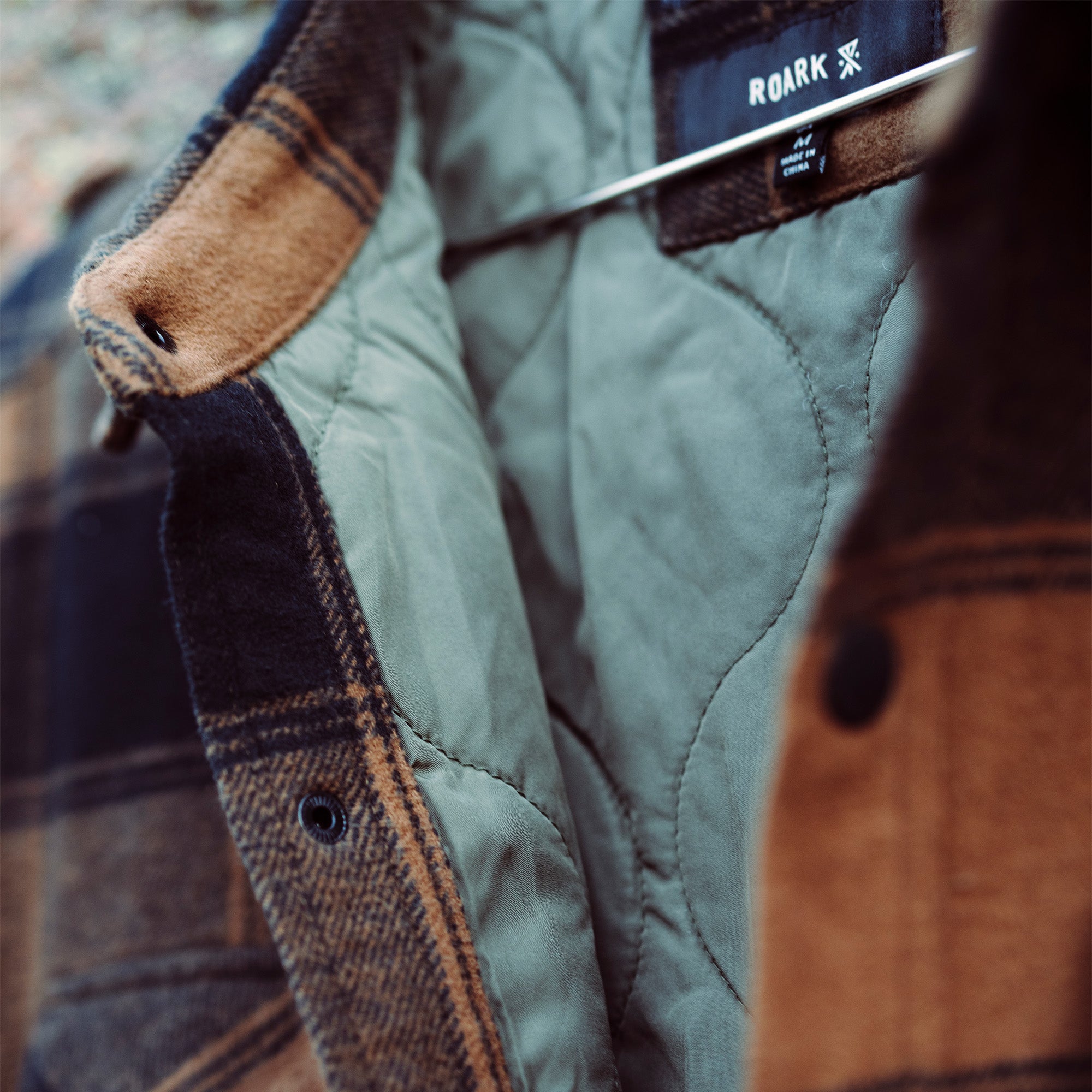 Rustic denim Backwoods Overshirt Jacket featuring prominent buttons and functional pockets, perfect for adventure and travel.