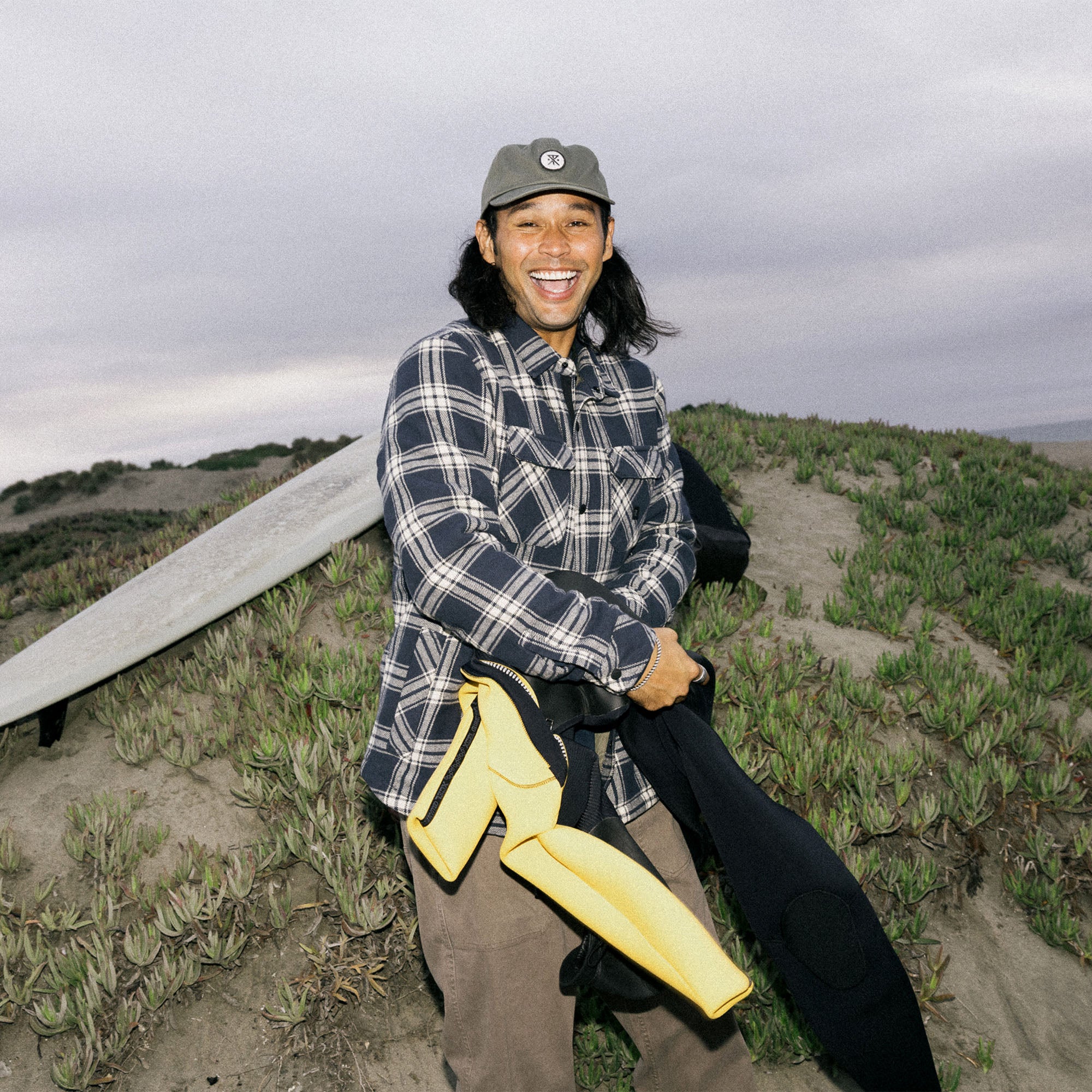 Man wearing a versatile Roark Backwoods Overshirt Jacket Flannel posing with various adventure hats for outdoor exploration.