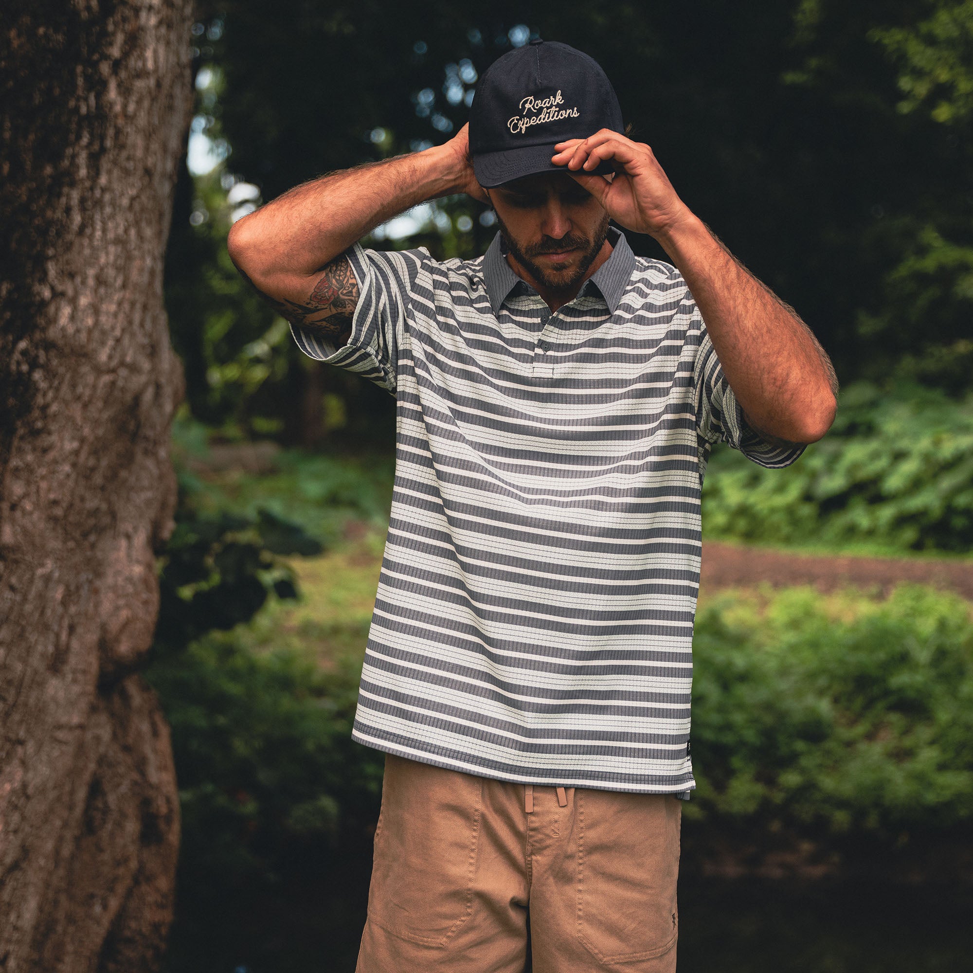 Person in a Bless Up Polo wearing a baseball cap, fitted for outdoor adventures and travel.