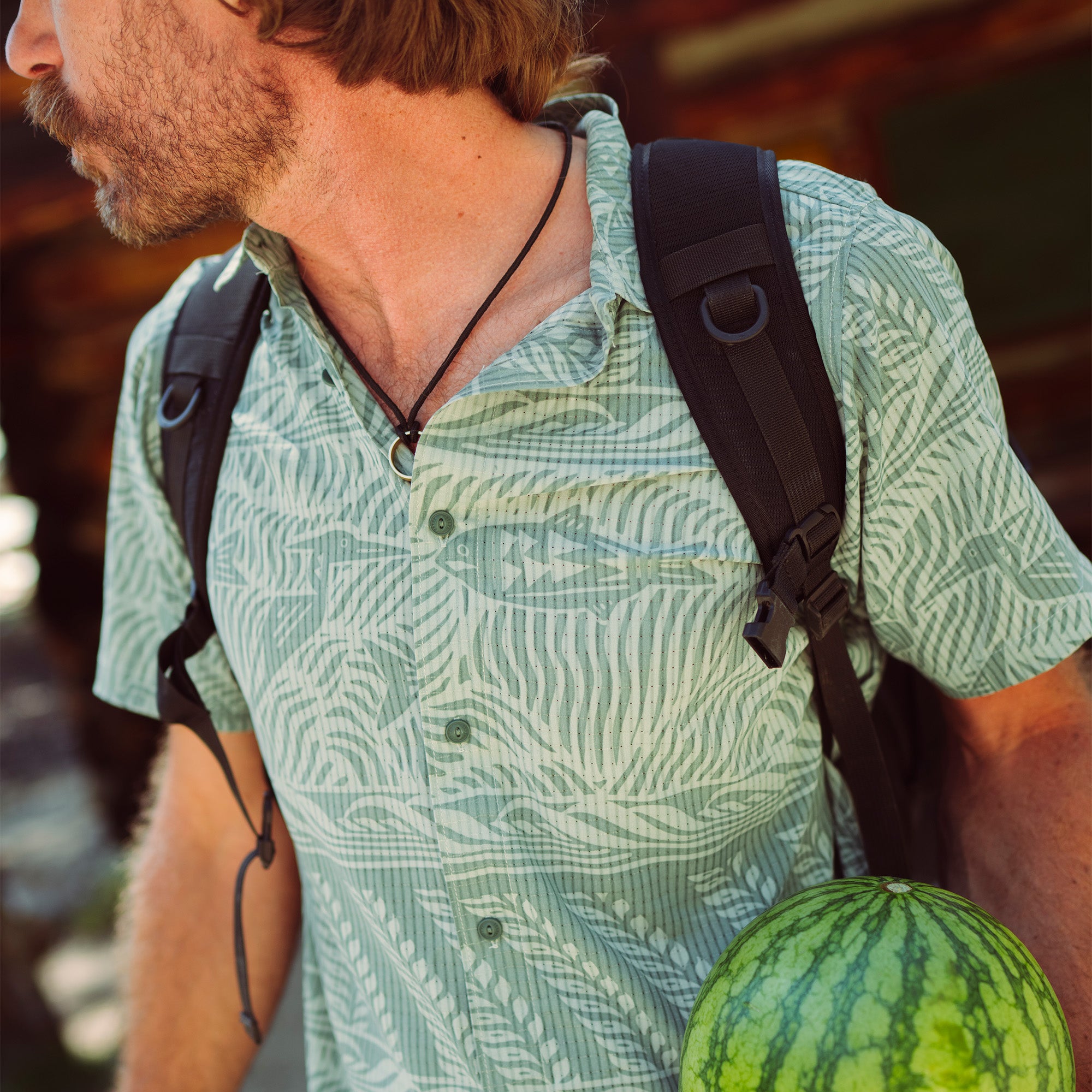Adventurous individual wearing a Roark Bless Up active shirt with a sun hat, ready for outdoor exploration.