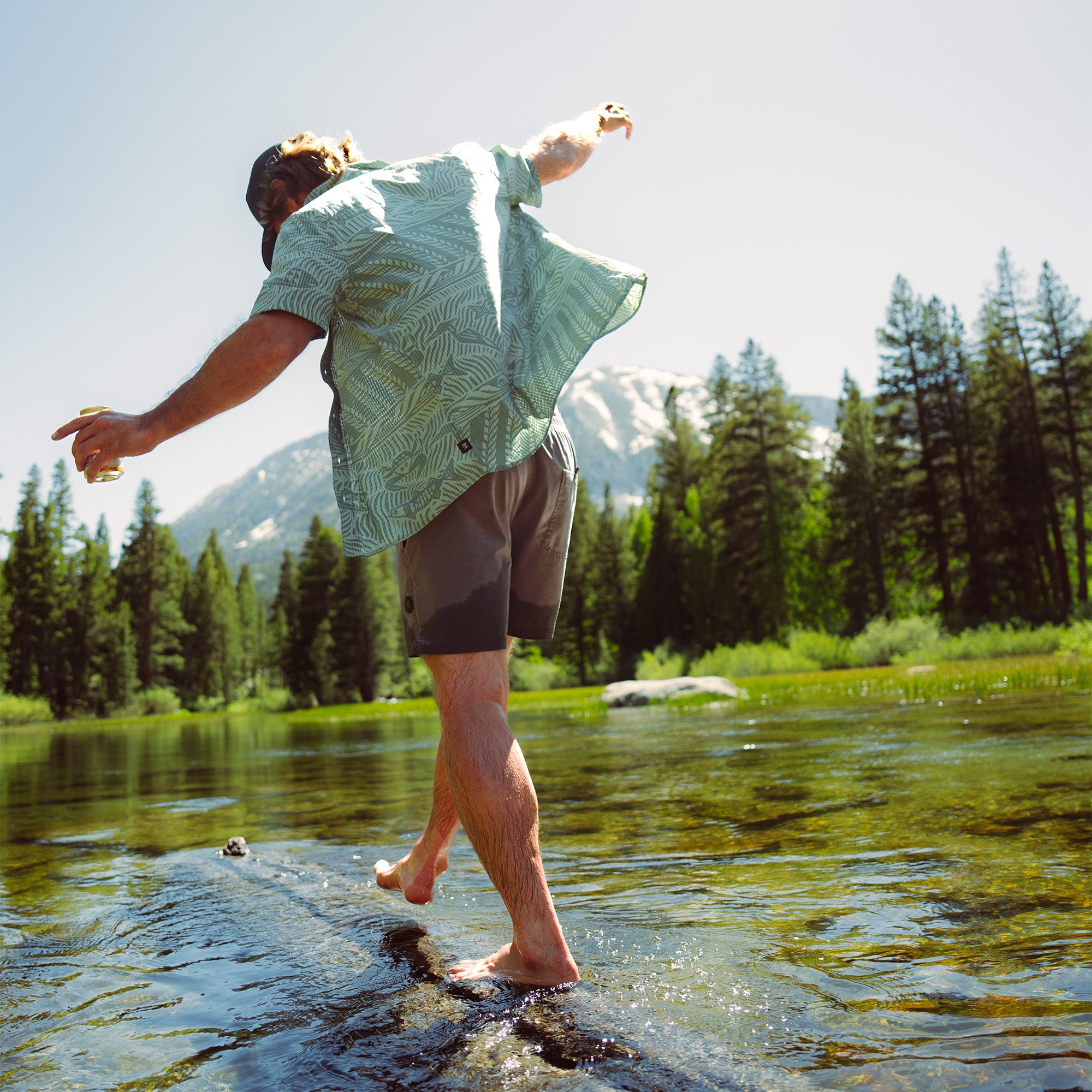 Group of friends enjoying outdoor fun and recreation, wearing casual shorts and engaged in leisure activities in nature