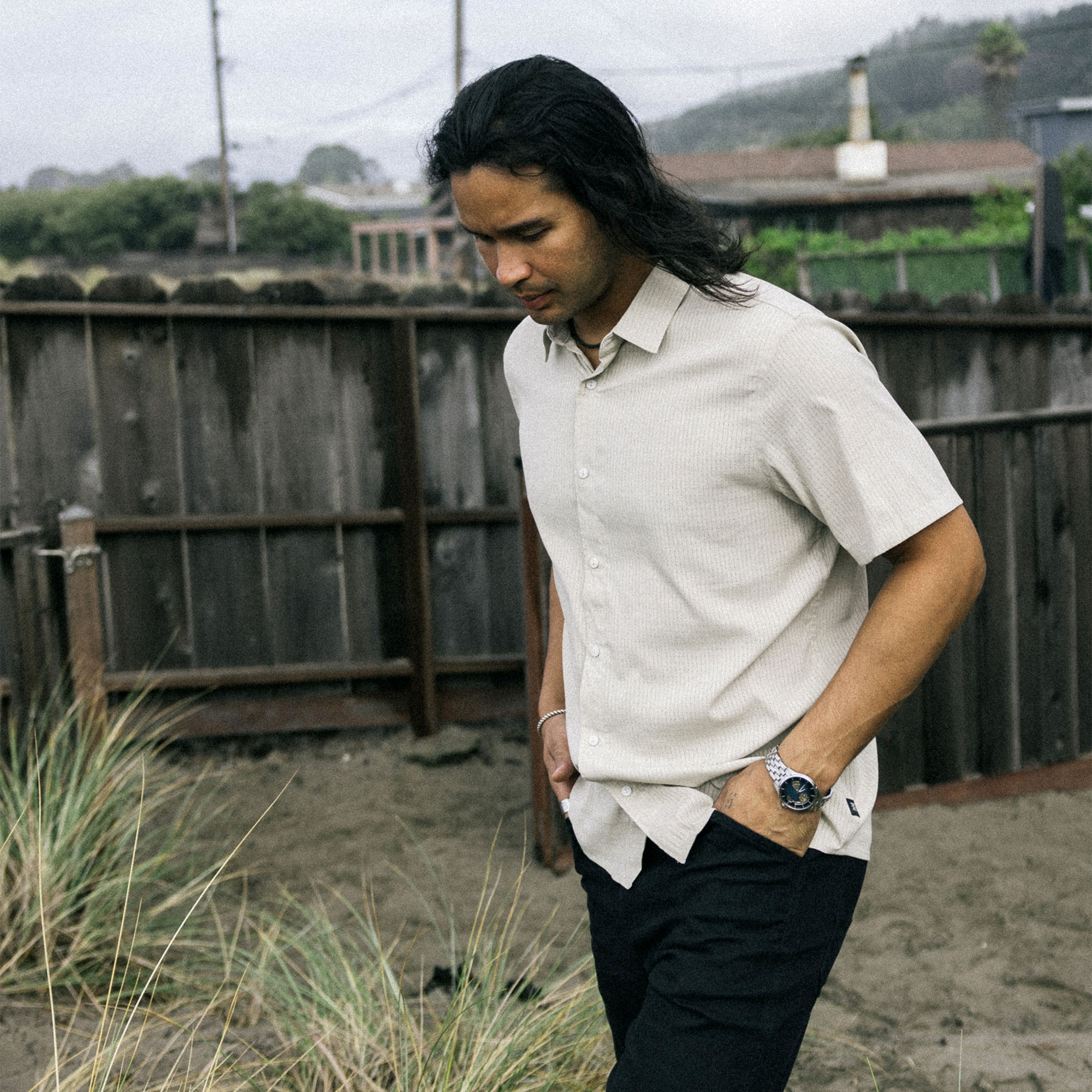 Close-up of the Bless Up shirt featuring detailed stitching on the sleeve, collar, and neck with visible buttons, perfect for outdoor adventures and travel.