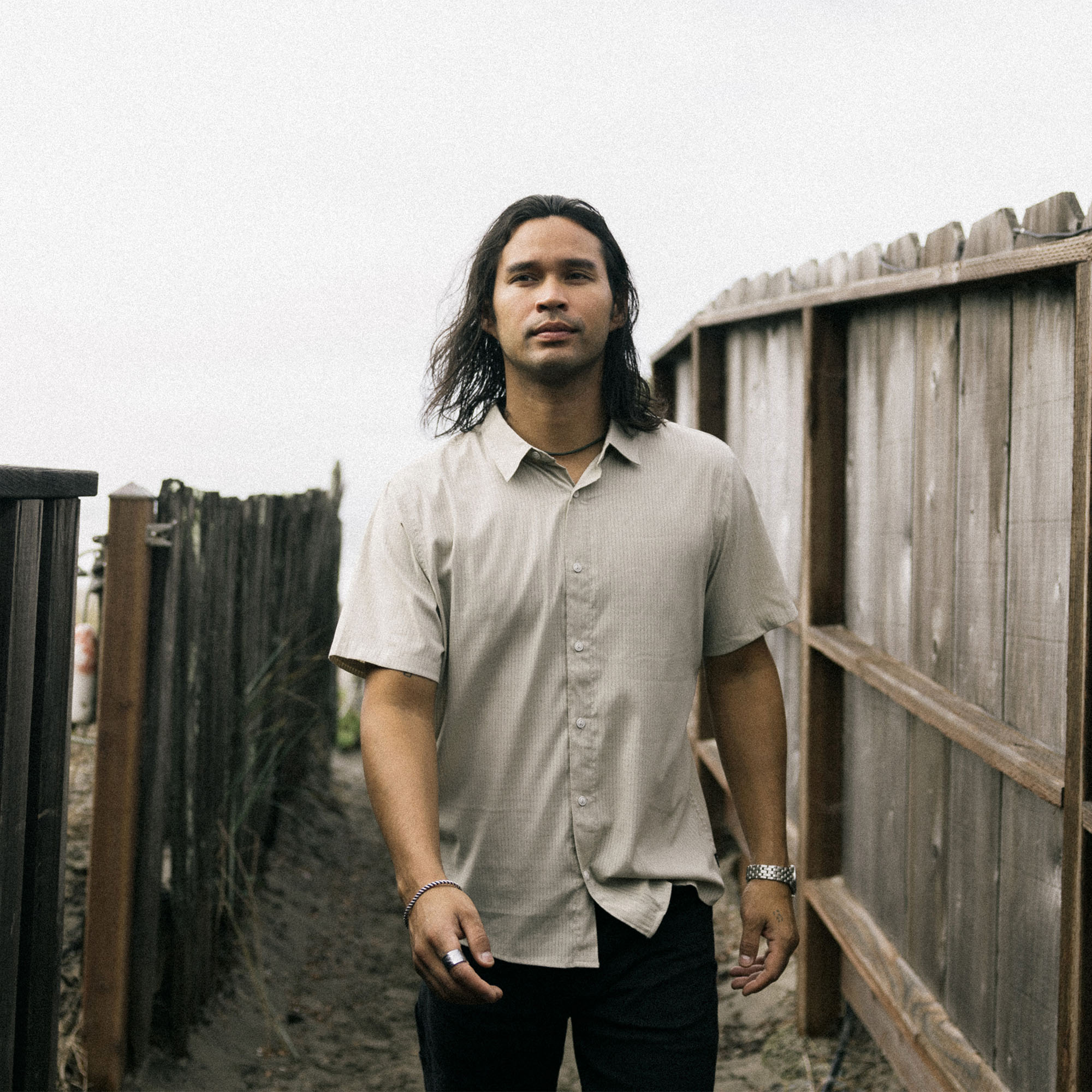 Man with black hair and facial hair wearing Roark's Bless Up Shirt featuring visible collar, shoulders, and sleeves, perfect for outdoor adventures.