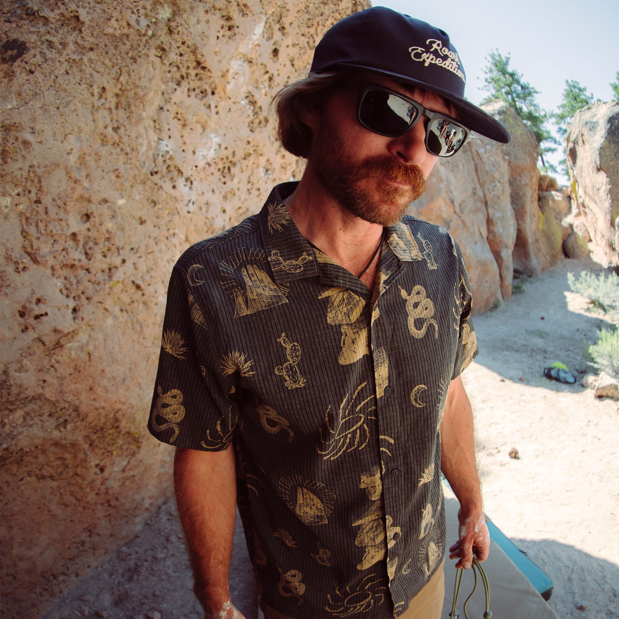 Outdoor adventurer wearing an active shirt and sun hat on a trail, embodying the spirit of exploration and travel
