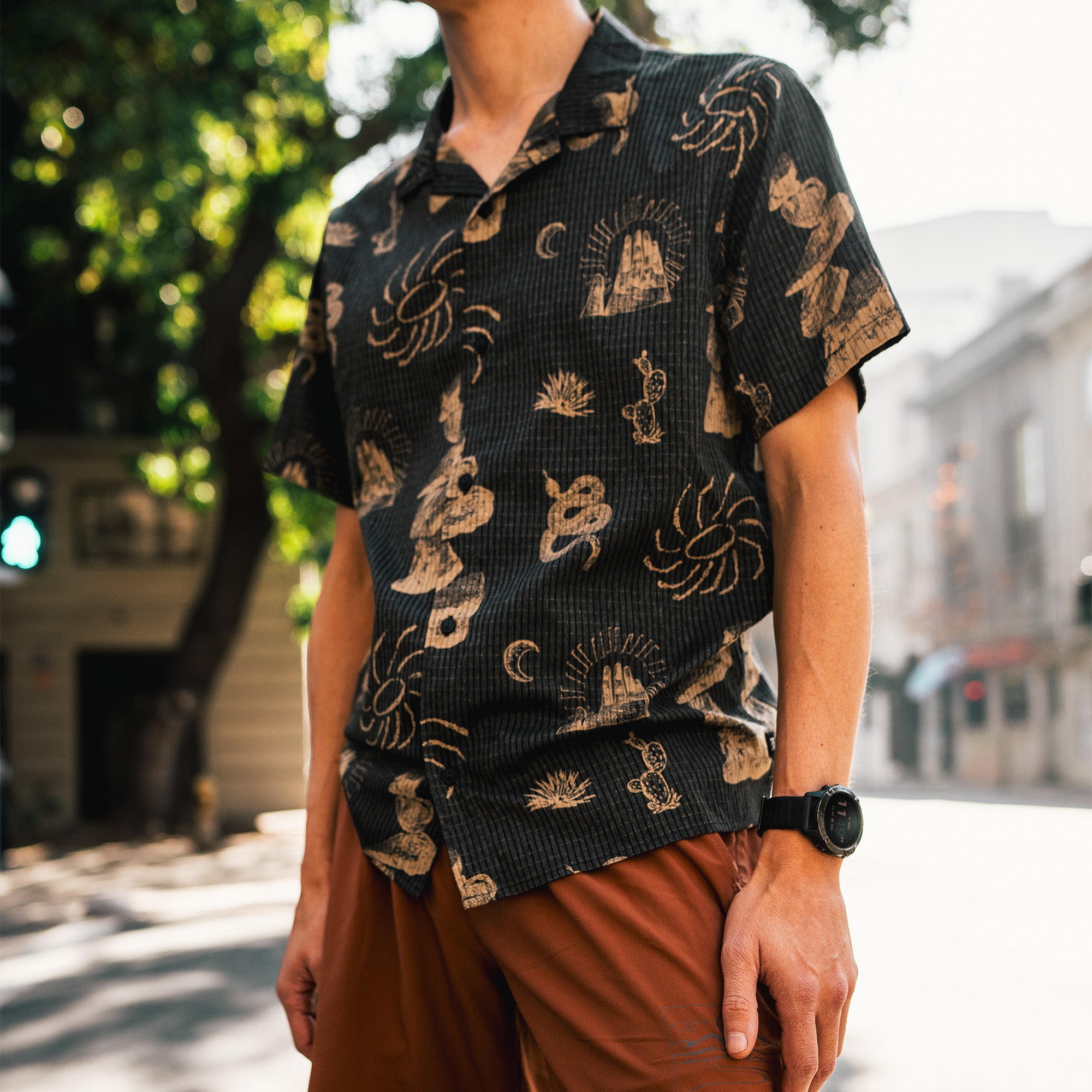 Close-up of high-performance active trail shirt featuring detailed sleeve, neck, and collar design with durable buttons, perfect for outdoor adventures.