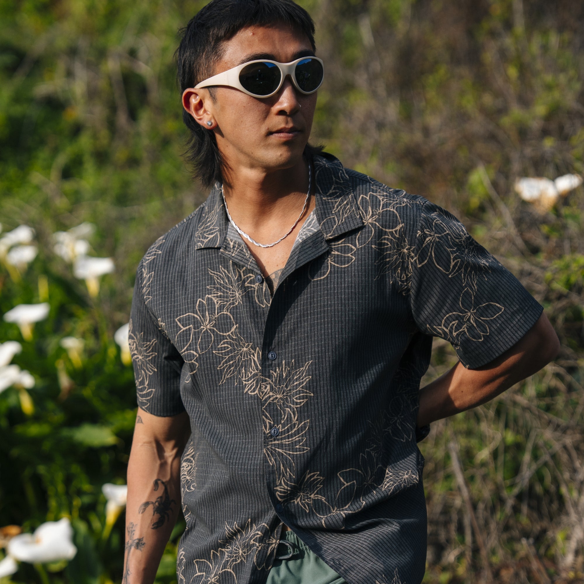 Active outdoor enthusiast wearing a Roark trail shirt with visible collar, button details, and sleeves designed for adventure and travel.