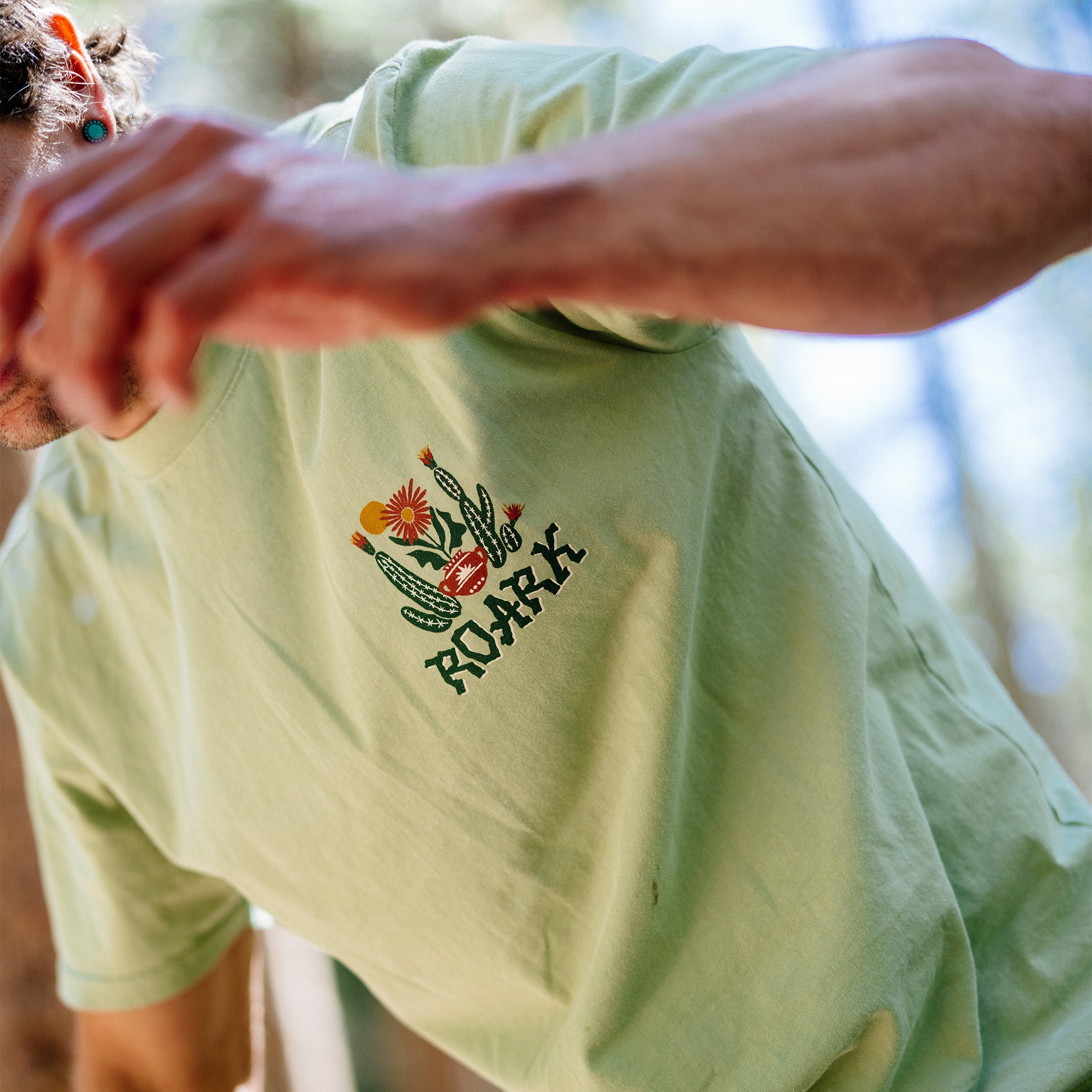 Close-up view of the Cactus Garden Premium Tee featuring distinctive Roark logo on a high-quality active shirt, ideal for adventure and travel.