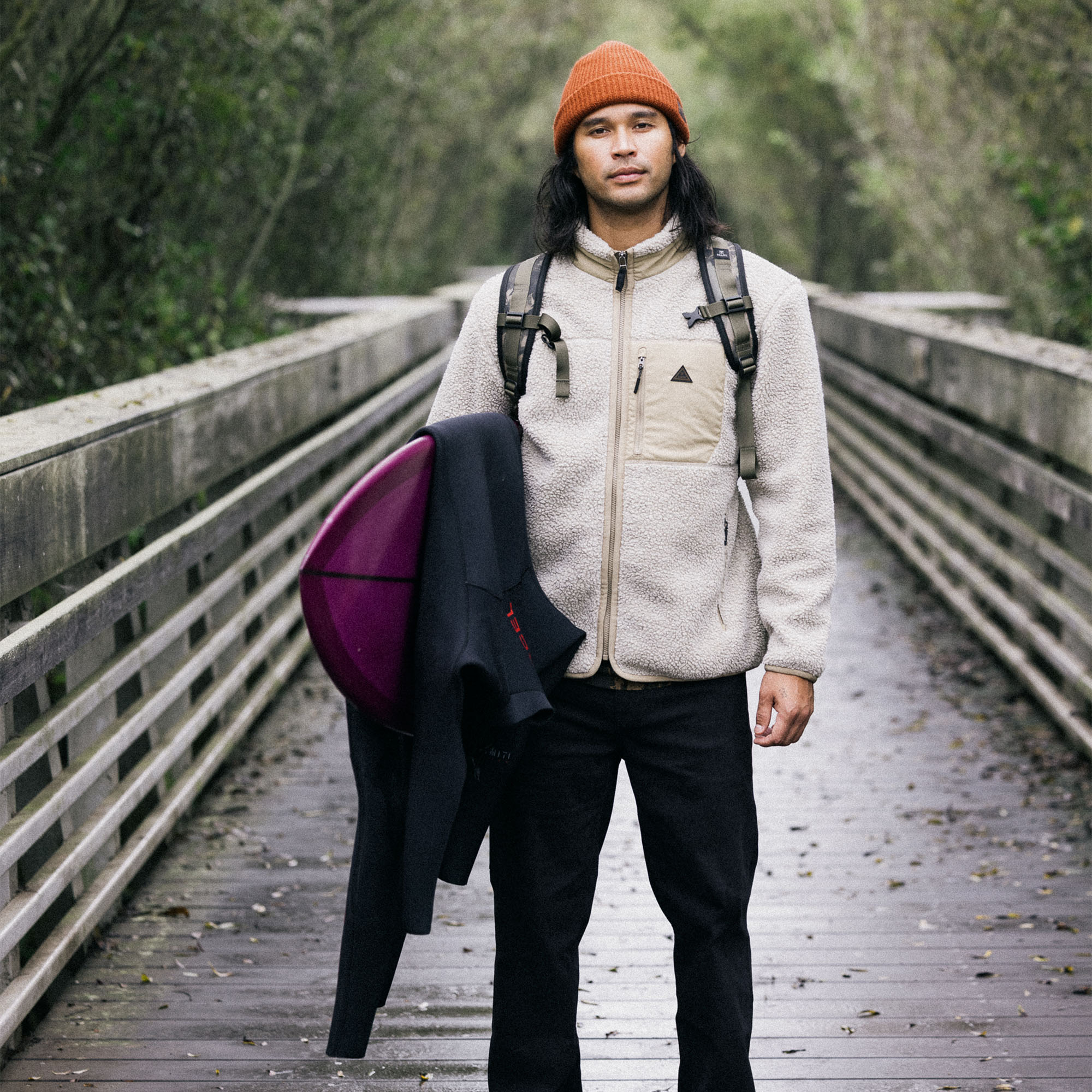 Man dressed warmly in a Campover Fleece Zip Hoodie by Roark, accessorized with a hat and cap, ready for outdoor winter adventures.