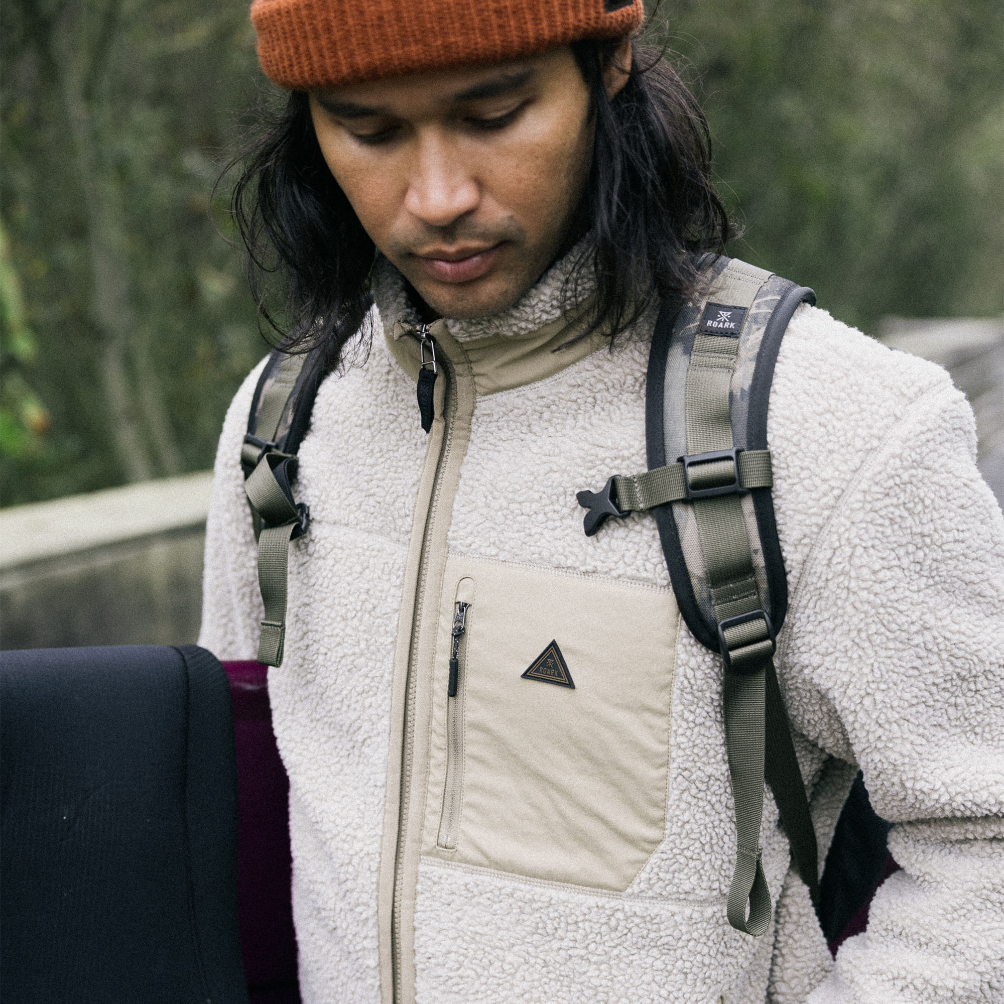 Person wearing Roark's Campover Fleece Zip Hoodie on a winter adventure vacation, showcasing warmth and style in an outdoor setting.