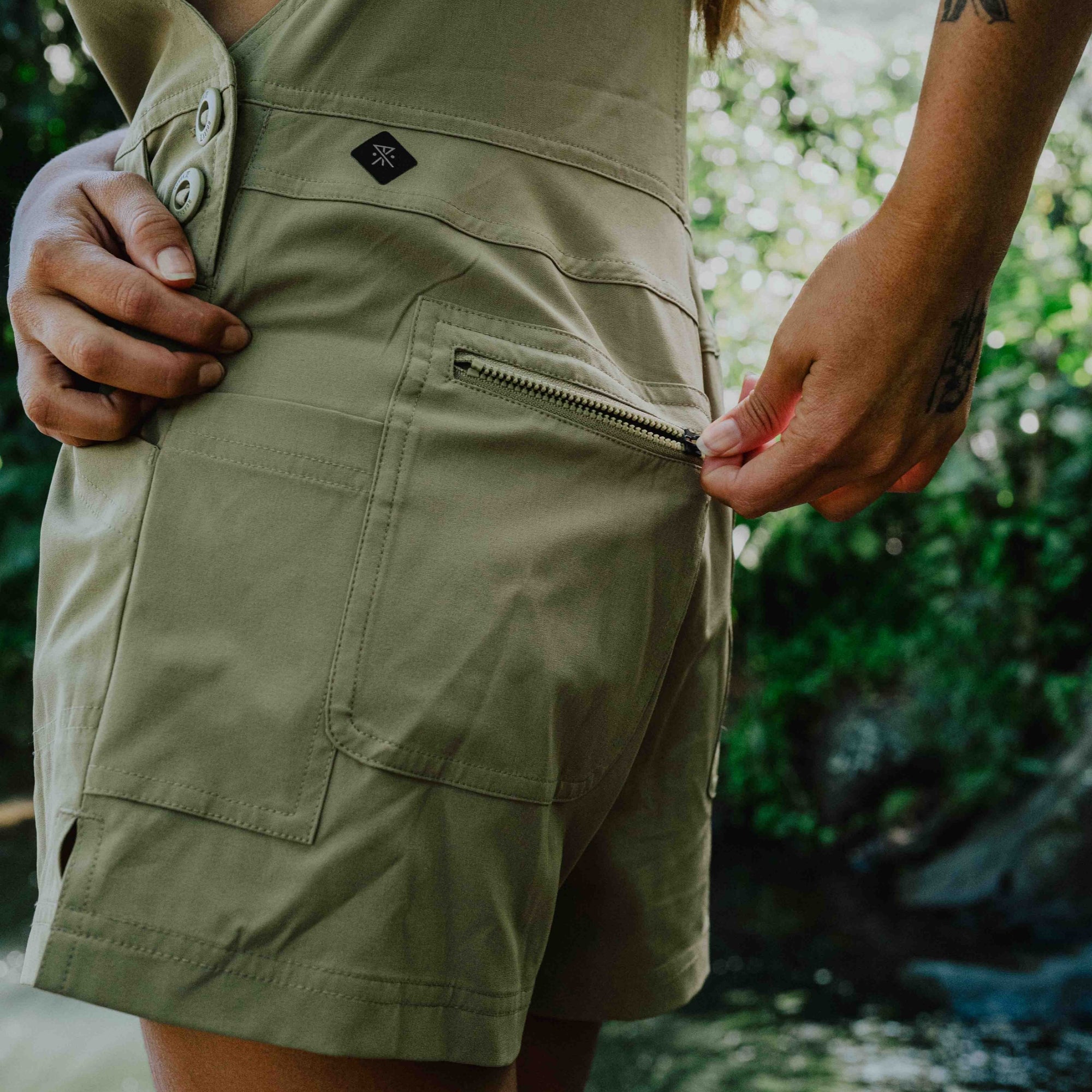 Group of adventurers enjoying a hike on a scenic trail in the Canyon wearing Roark's versatile rompers, perfect for outdoor exploration.