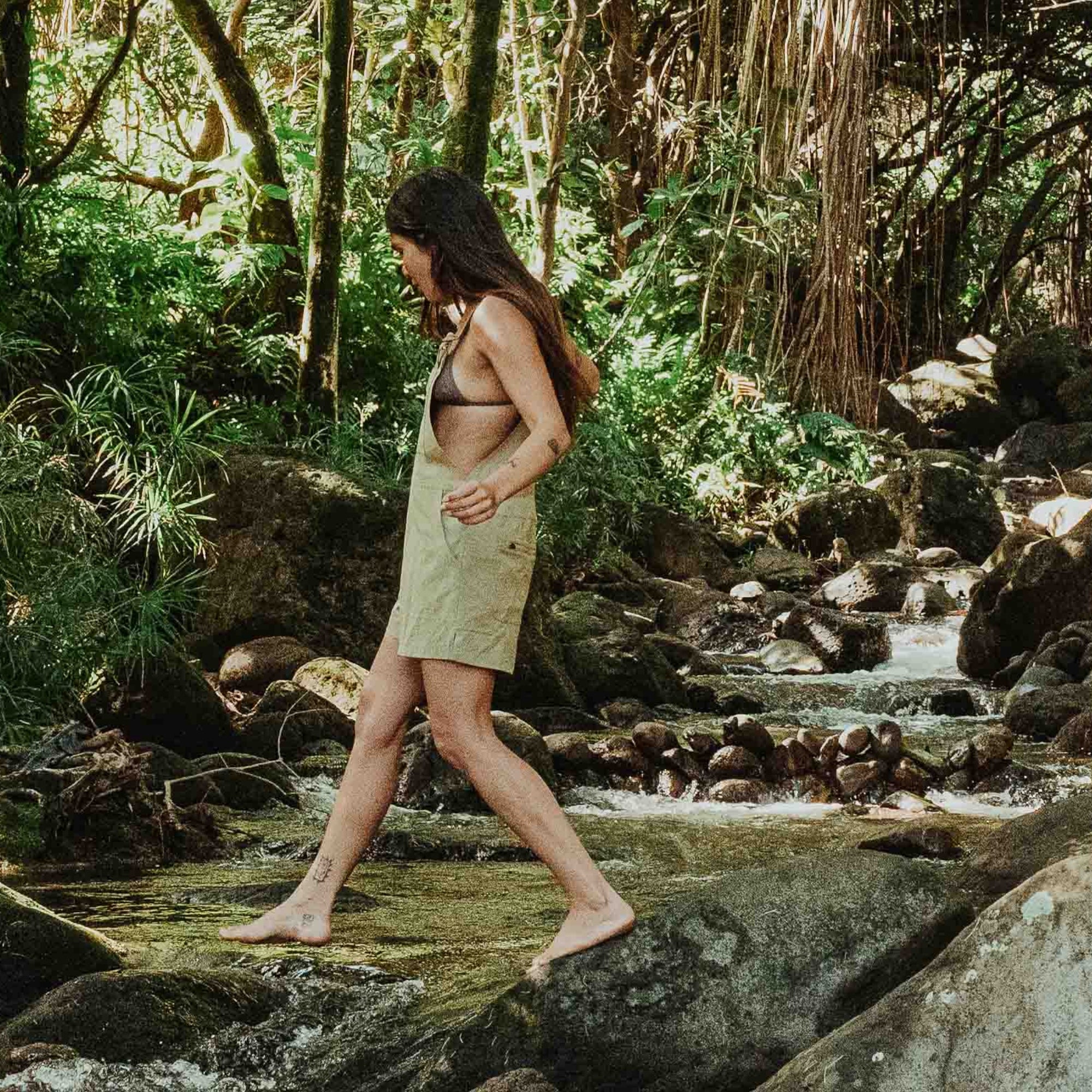 Person wearing a stylish romper while exploring a lush jungle setting, perfectly blending adventure with fashion.