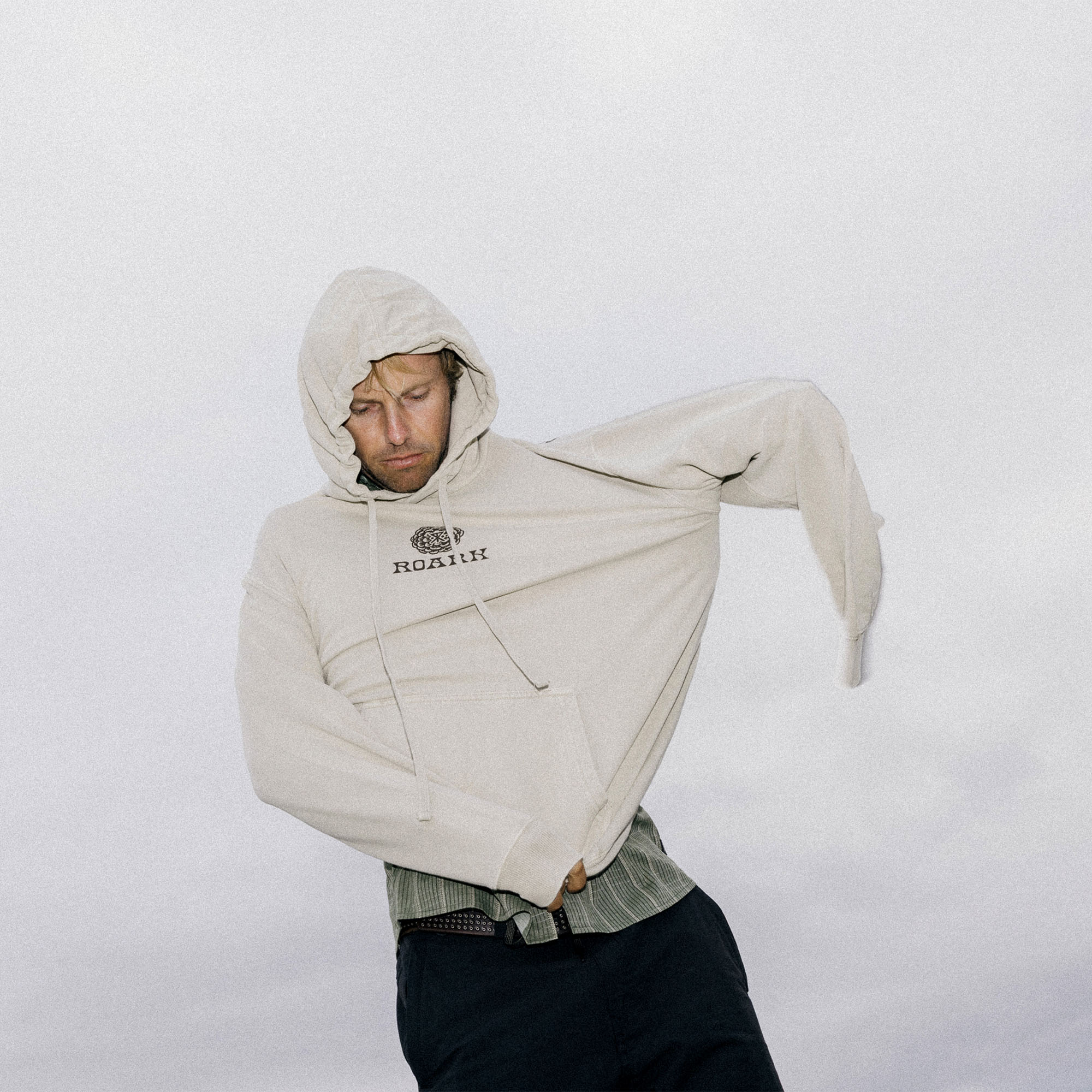 Outdoor enthusiast wearing a cozy Cone Collectors fleece hoodie with deep pockets and an adjustable hood, ideal for brisk adventures.