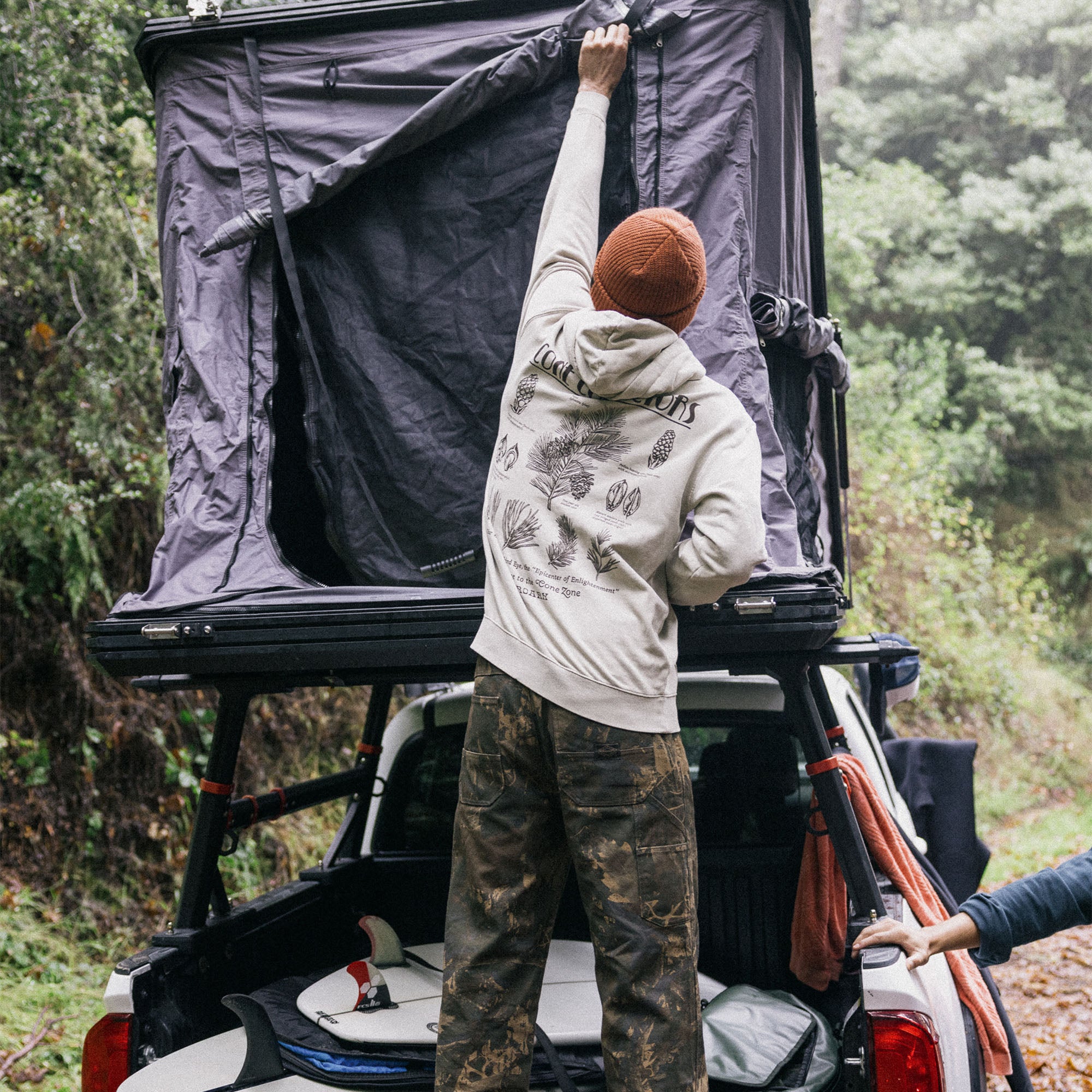 Adventure-ready Jeep equipped with an automotive carrying rack parked beside a railing, set in a rugged outdoor location, showcasing the spirit of exploration.