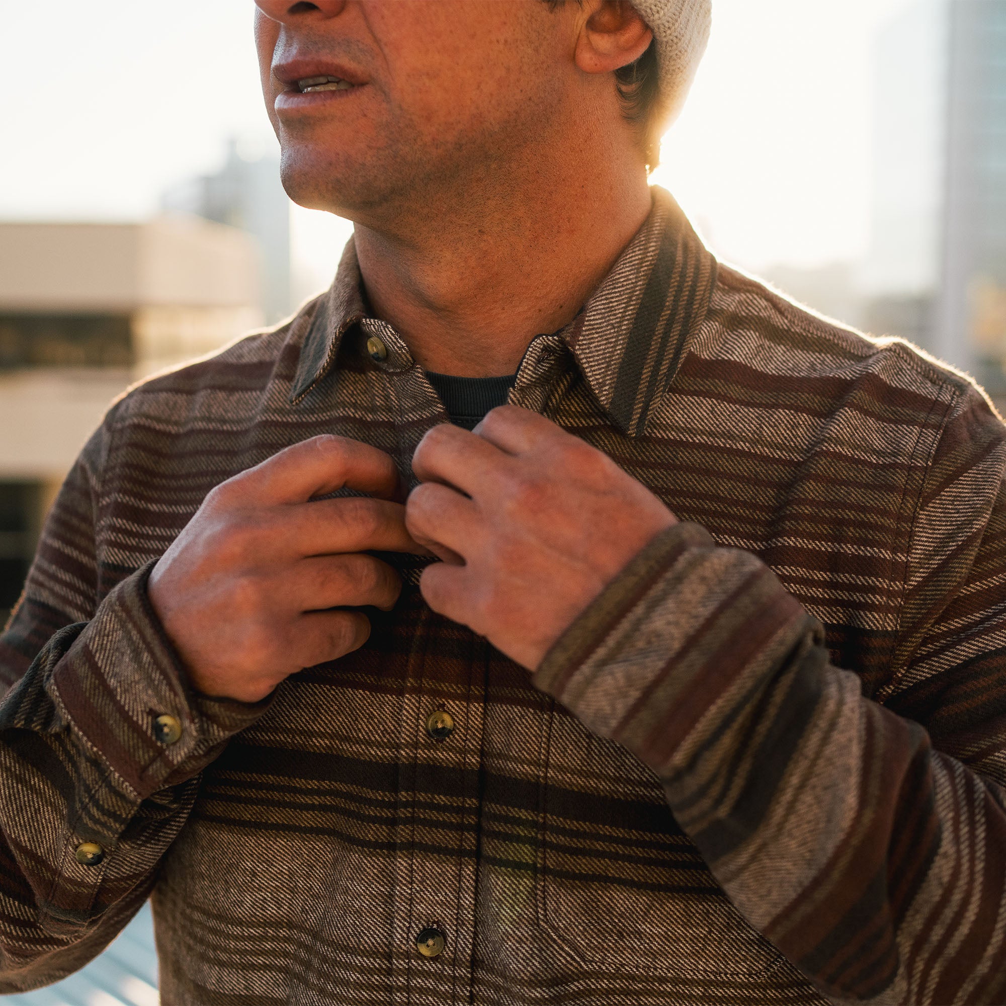 Brown plaid organic cotton flannel shirt with button details, ideal for adventure and travel, by Roark