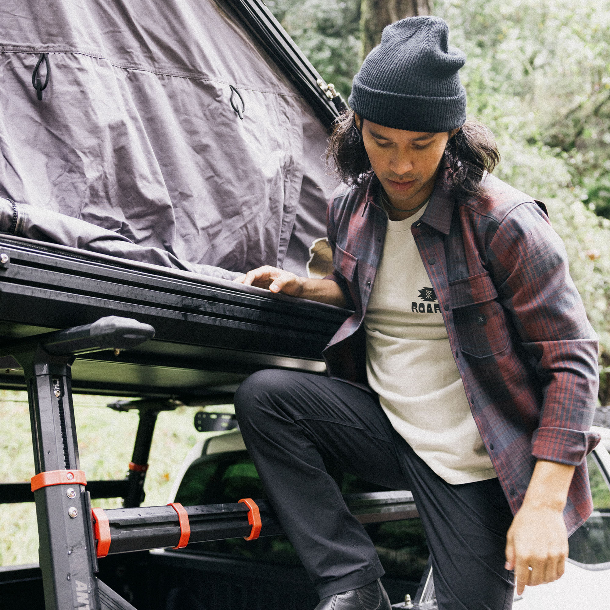 SUV equipped with a rugged roof rack parked beside railings, highlighting the adventurous and travel-ready lifestyle.