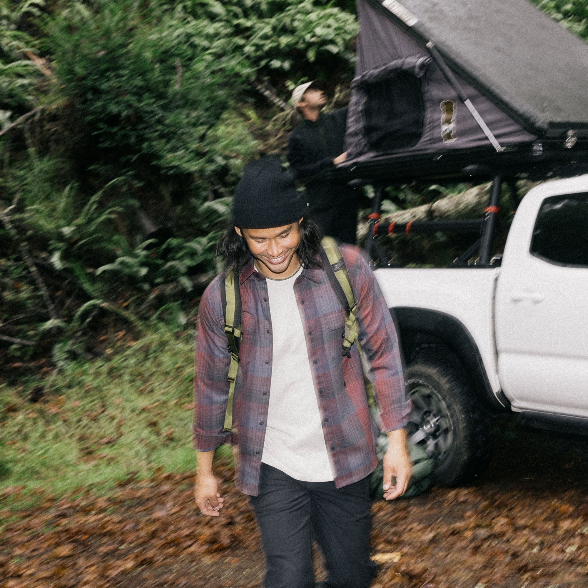 Person camping in an adventurous setting while wearing the Roark Diablo Long Sleeve Flannel, perfect for outdoor activities.