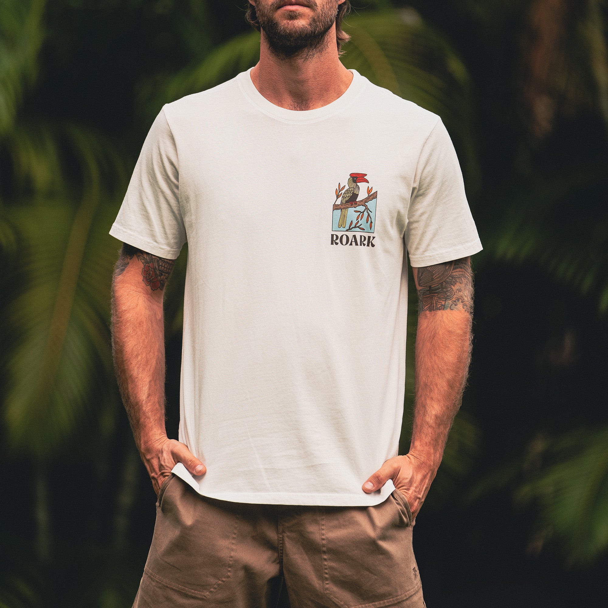 Man in adventure-ready Roark active shirt and boardshorts, ideal for outdoor escapades