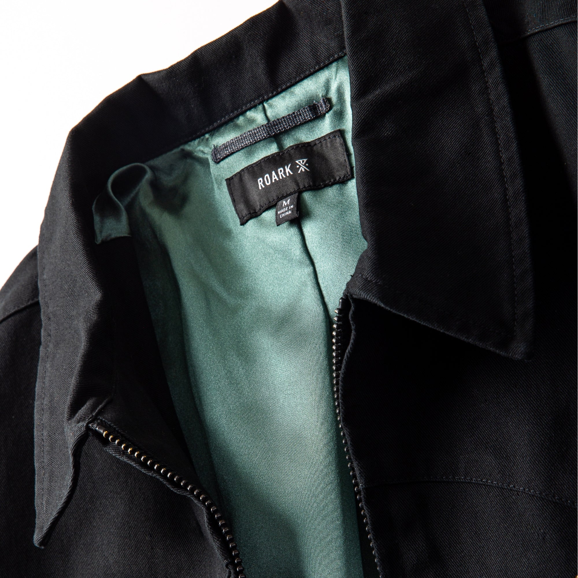 Close-up of the Forever Roaming Jacket featuring durable denim with leather accents, highlighting the collar, pockets, and textures ideal for adventure and travel.