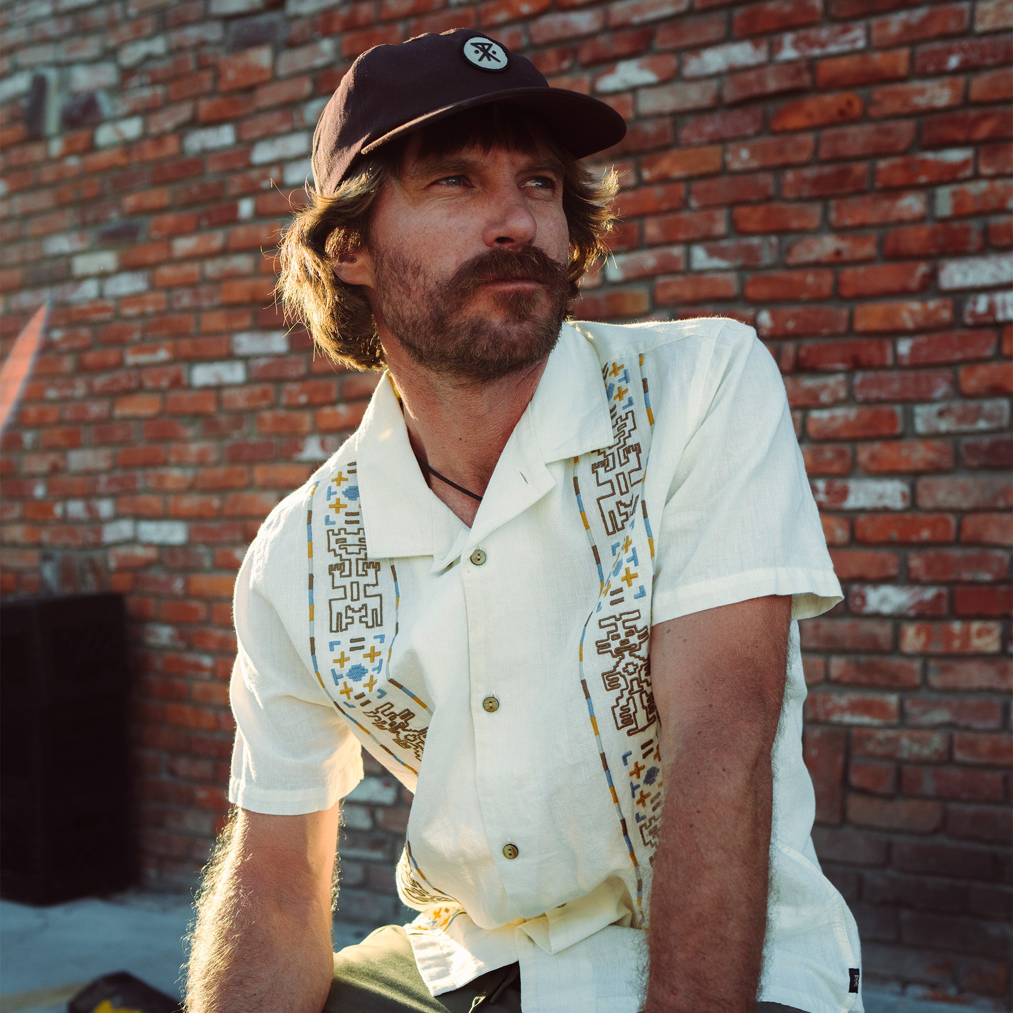 Man in a stylish Gonzo Camp Shirt from Roark's Fall 2025 collection wearing a hat, showcasing outdoor adventure-ready apparel.