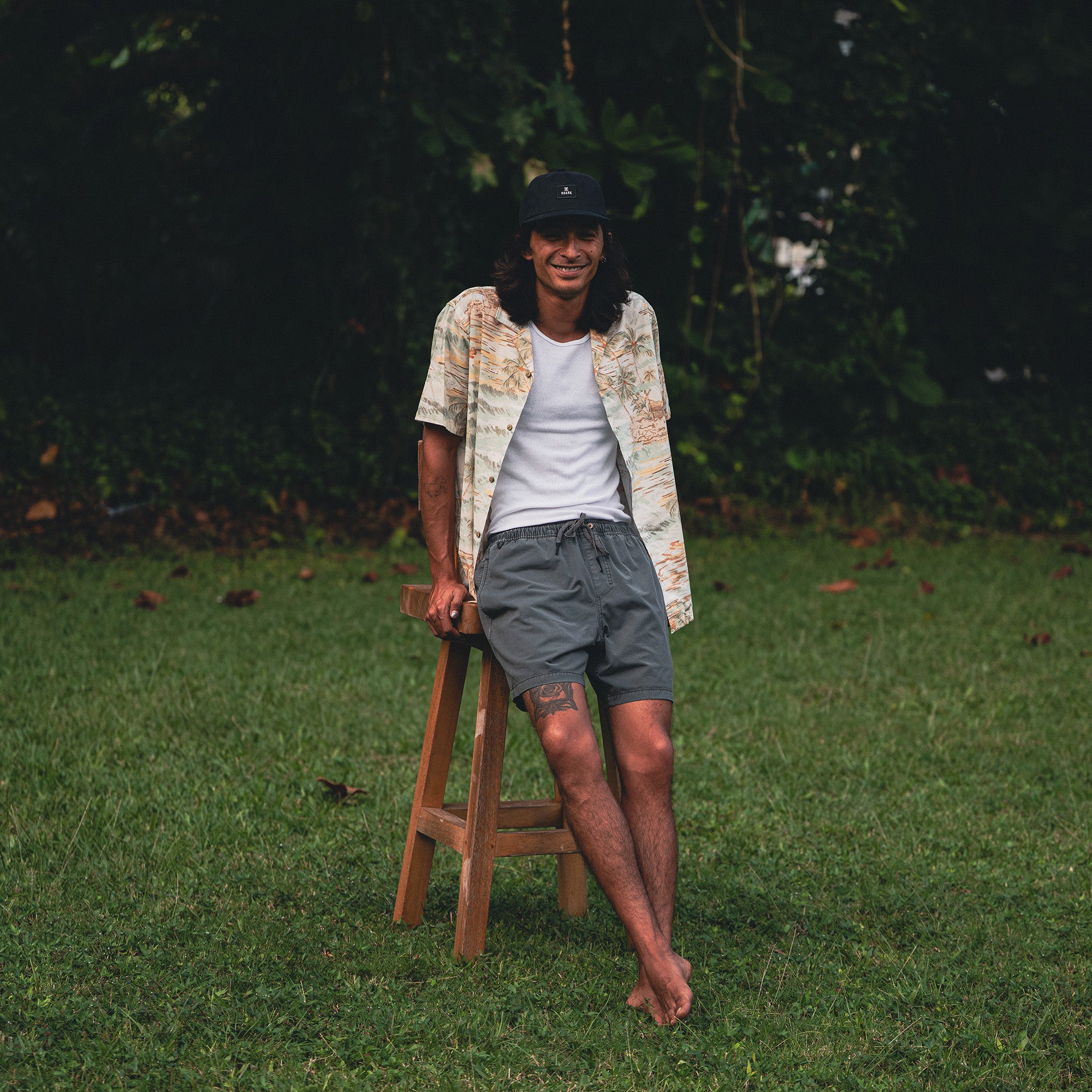 Man wearing Roark's Gonzo Short Sleeve Button Up shirt paired with Bermuda shorts, perfect for a summer adventure