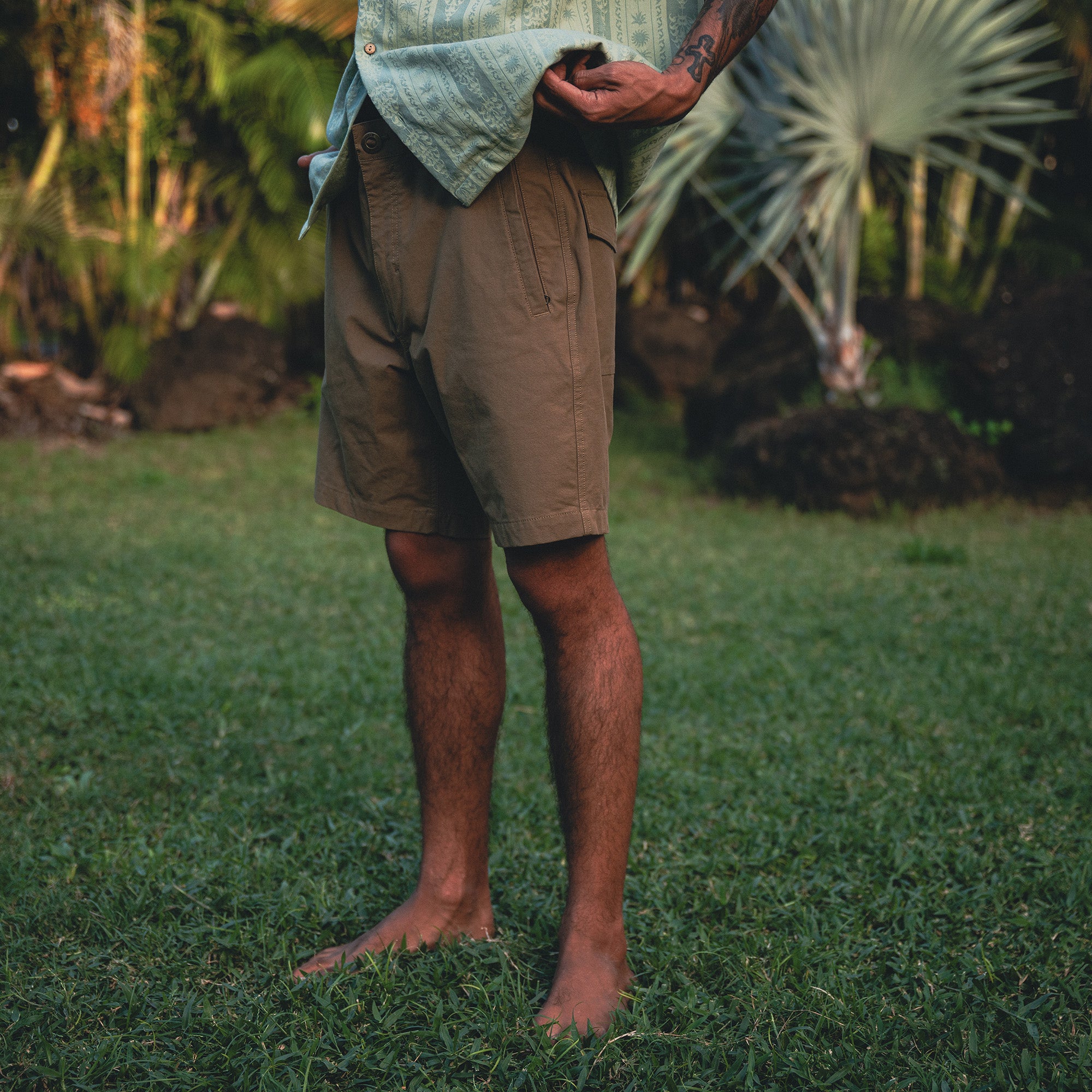 Group of adventurers in nature wearing Roark's Gonzo Short Sleeve Button Up Shirts and boardshorts, highlighting a laid-back and rugged outdoor style.