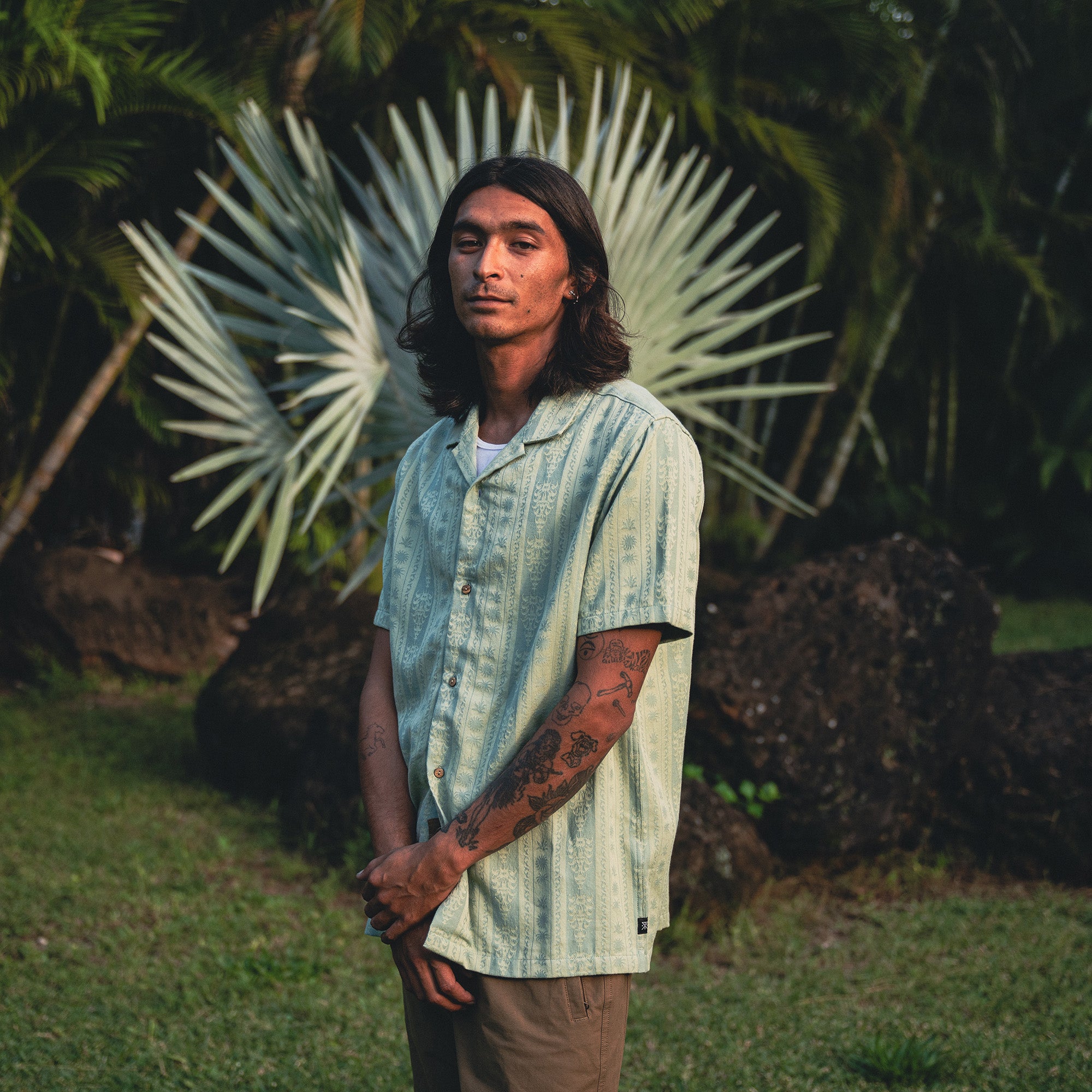 Adventurous person wearing Roark's Gonzo Short Sleeve Button Up Shirt in a natural outdoor setting, emphasizing style and comfort for active wear.