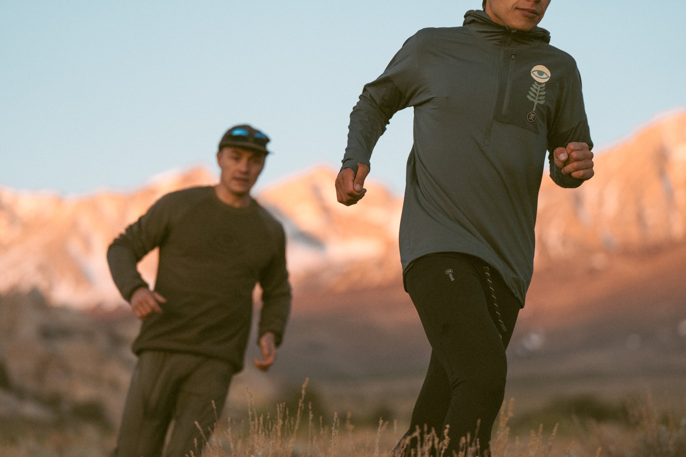 Man running through outdoor landscape wearing sportswear, embodying Roark's adventurous spirit