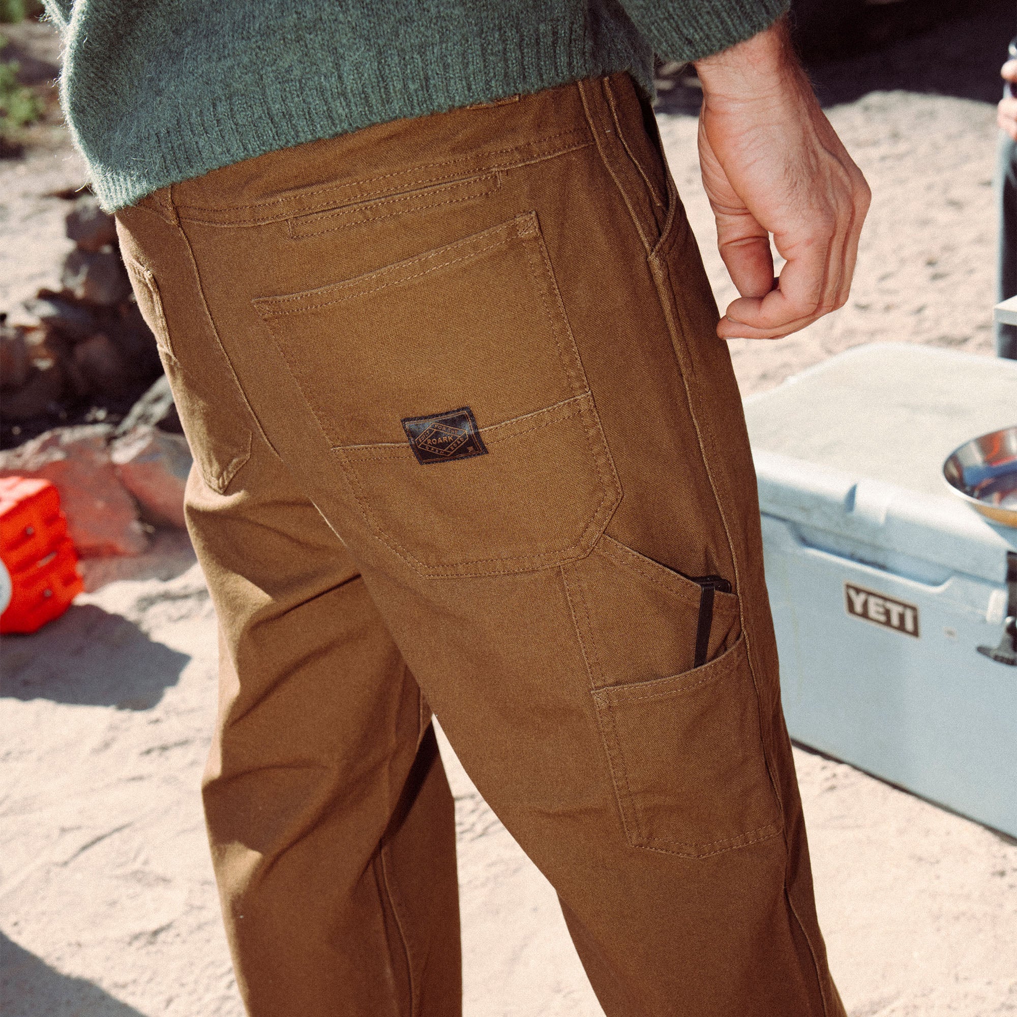 Close-up of the rugged features on Roark's HWY 1 Utility Denim, showcasing durable brown denim with detailed stitching and practical pockets, ideal for outdoor adventures.
