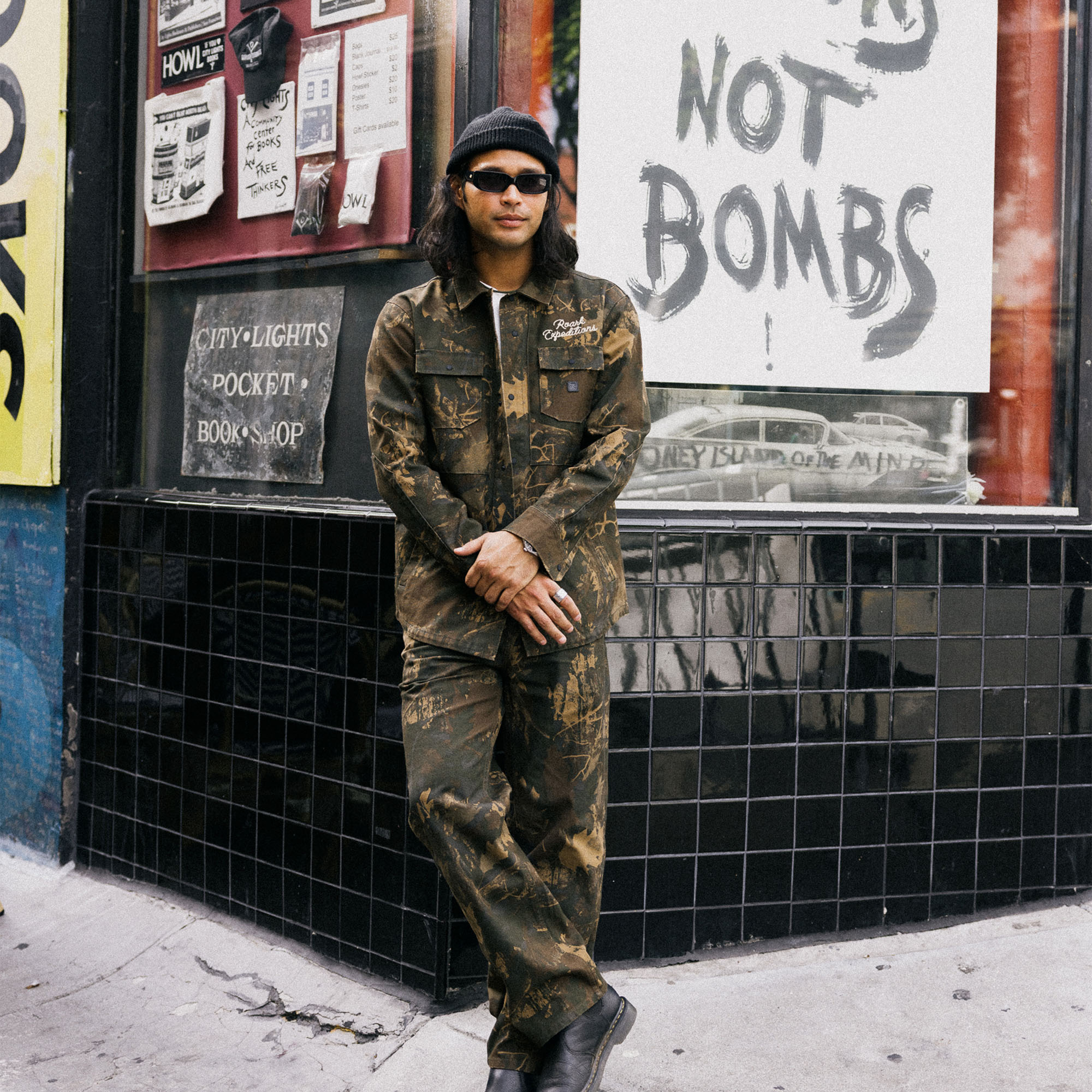Model wearing Roark Hebrides Unlined Camouflage Jacket, styled for military-inspired outdoor adventure