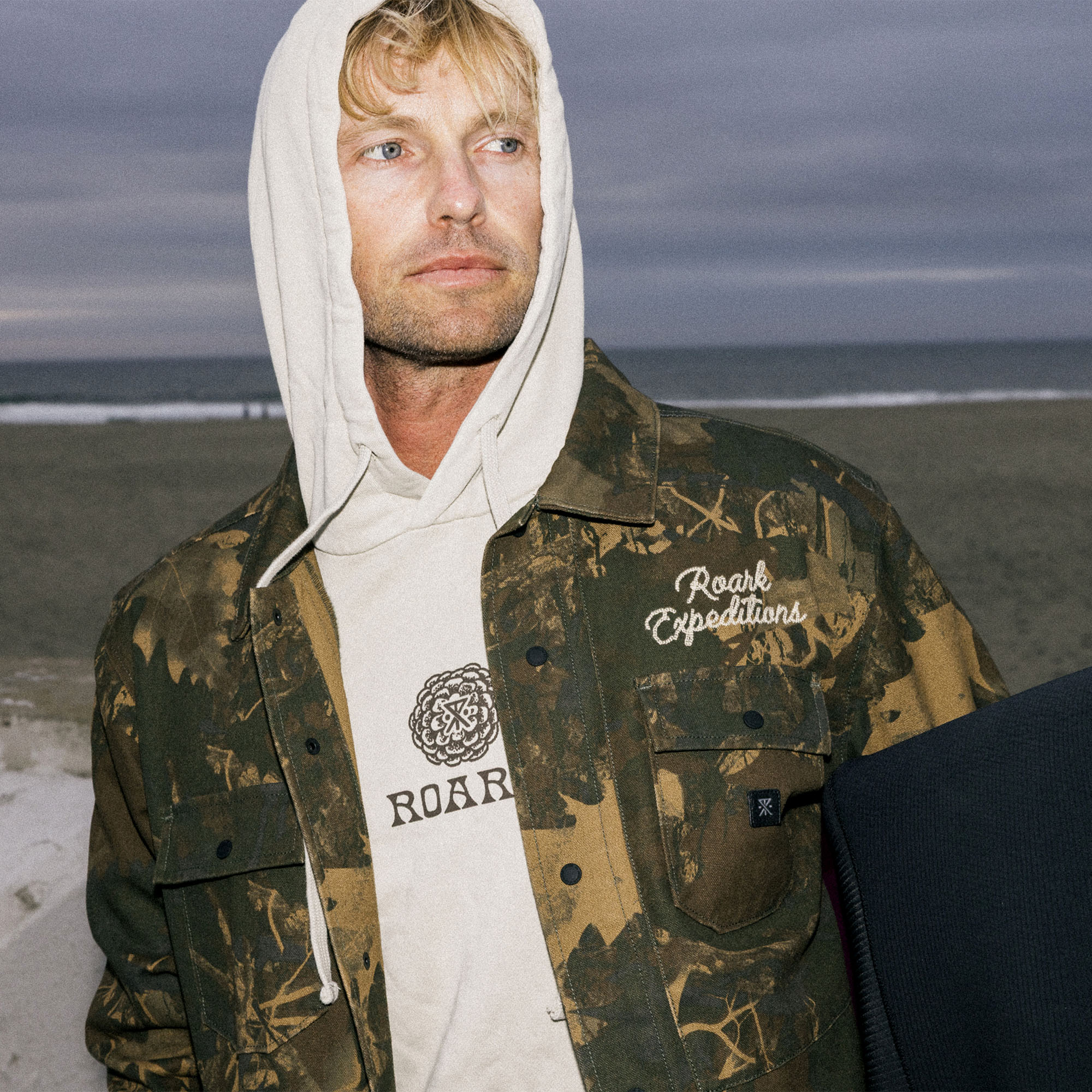 Roark Hebrides unlined denim jacket featuring a hood, ideal for adventurous travels and outdoor exploration.