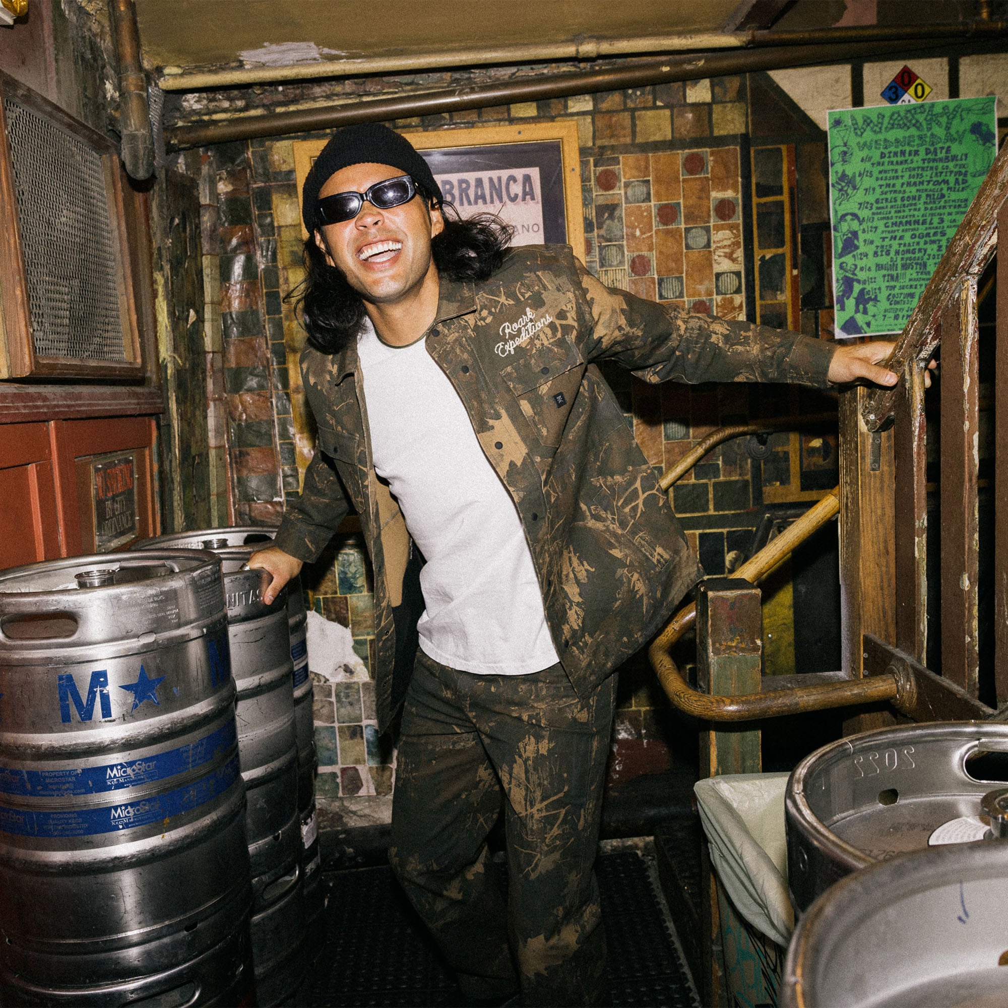 Person in Hebrides unlined jacket enjoying a night adventure outdoors, wearing a camouflage cap and blending into the surroundings for a fun excursion.