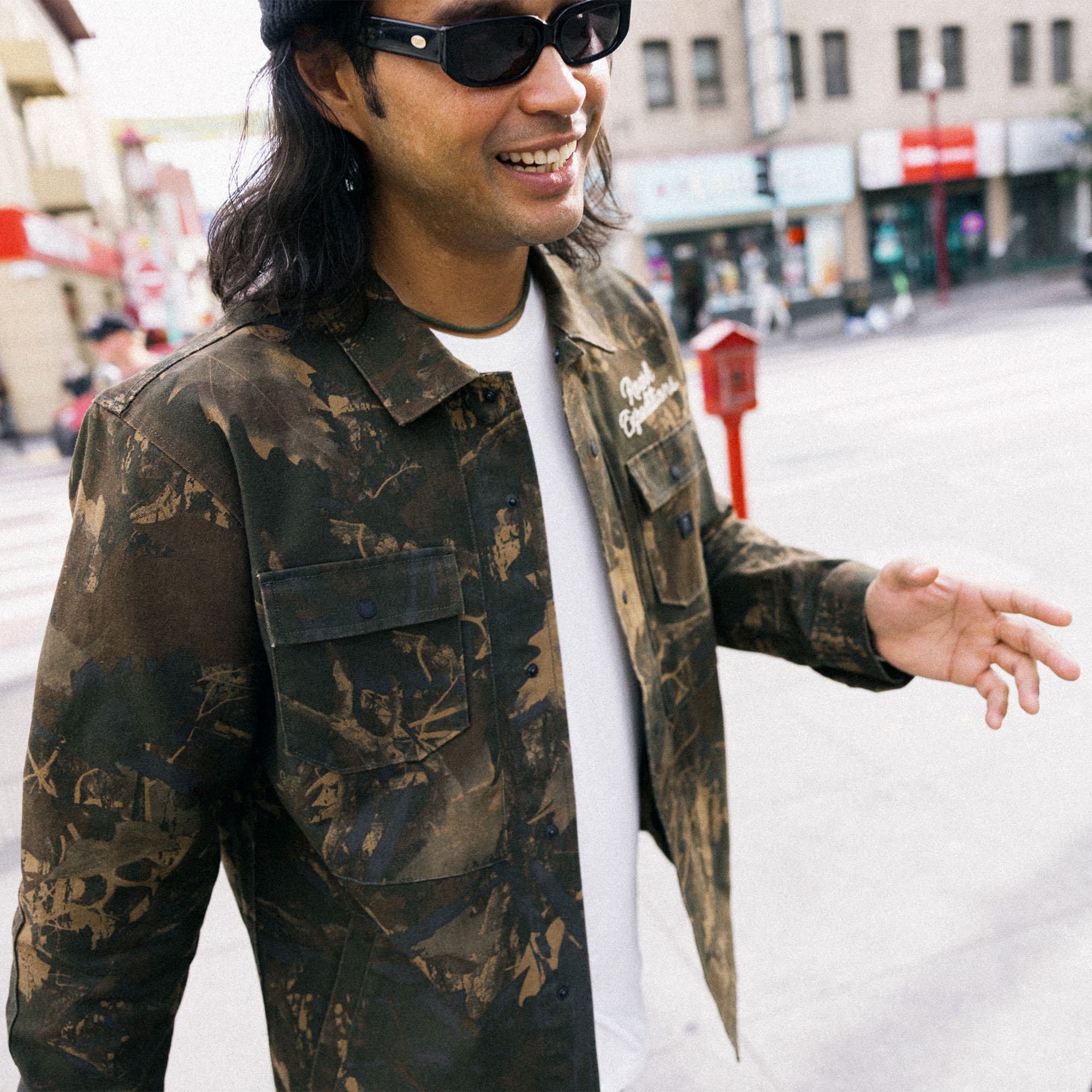 Roark Hebrides unlined denim jacket featuring military camouflage sleeves, designed for adventure and outdoor travel.