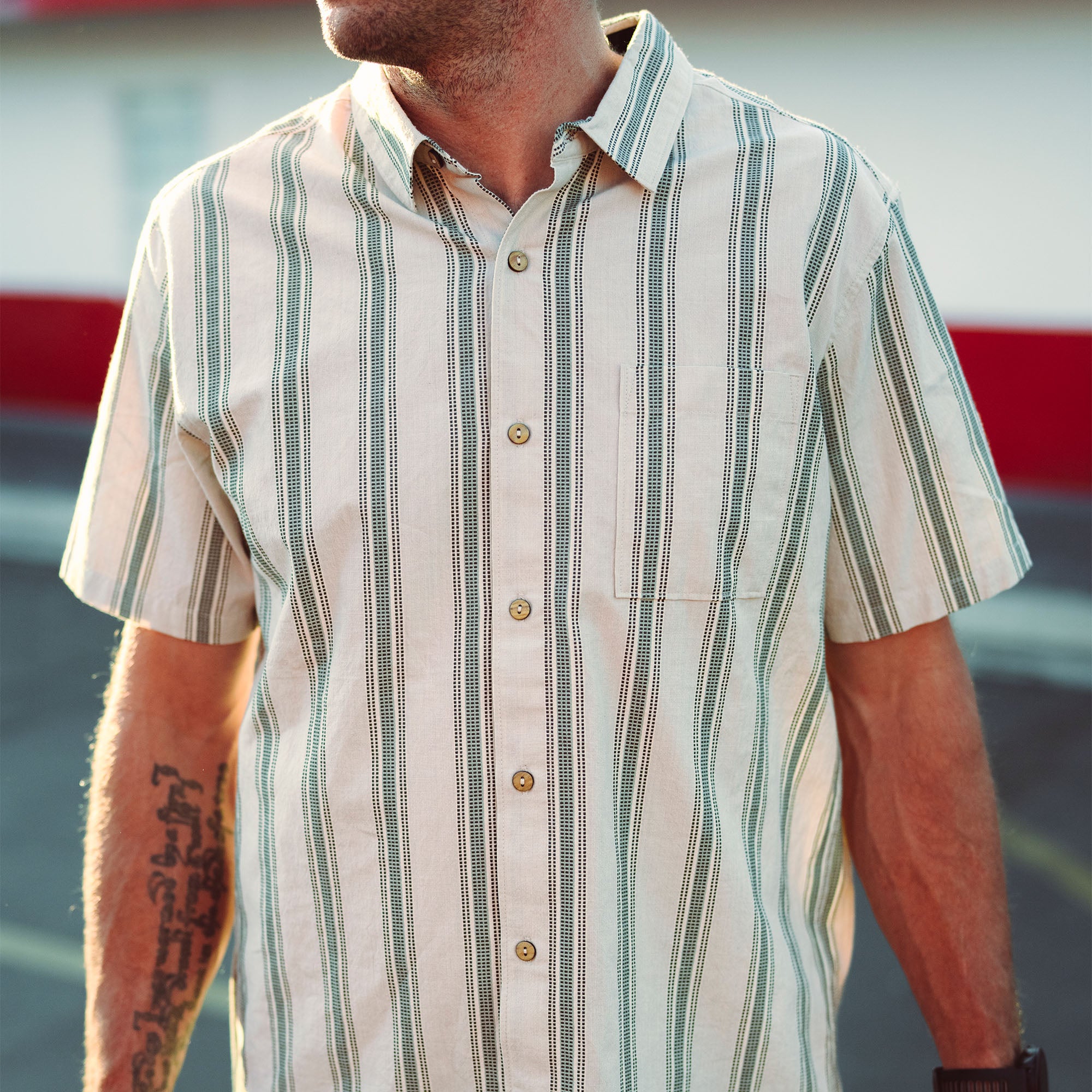 Close-up of a Roark Journey dress shirt from Fall 2025 collection featuring detailed stitching on the collar, button line, and pocket against an outdoor-inspired backdrop, ideal for travel and adventure.