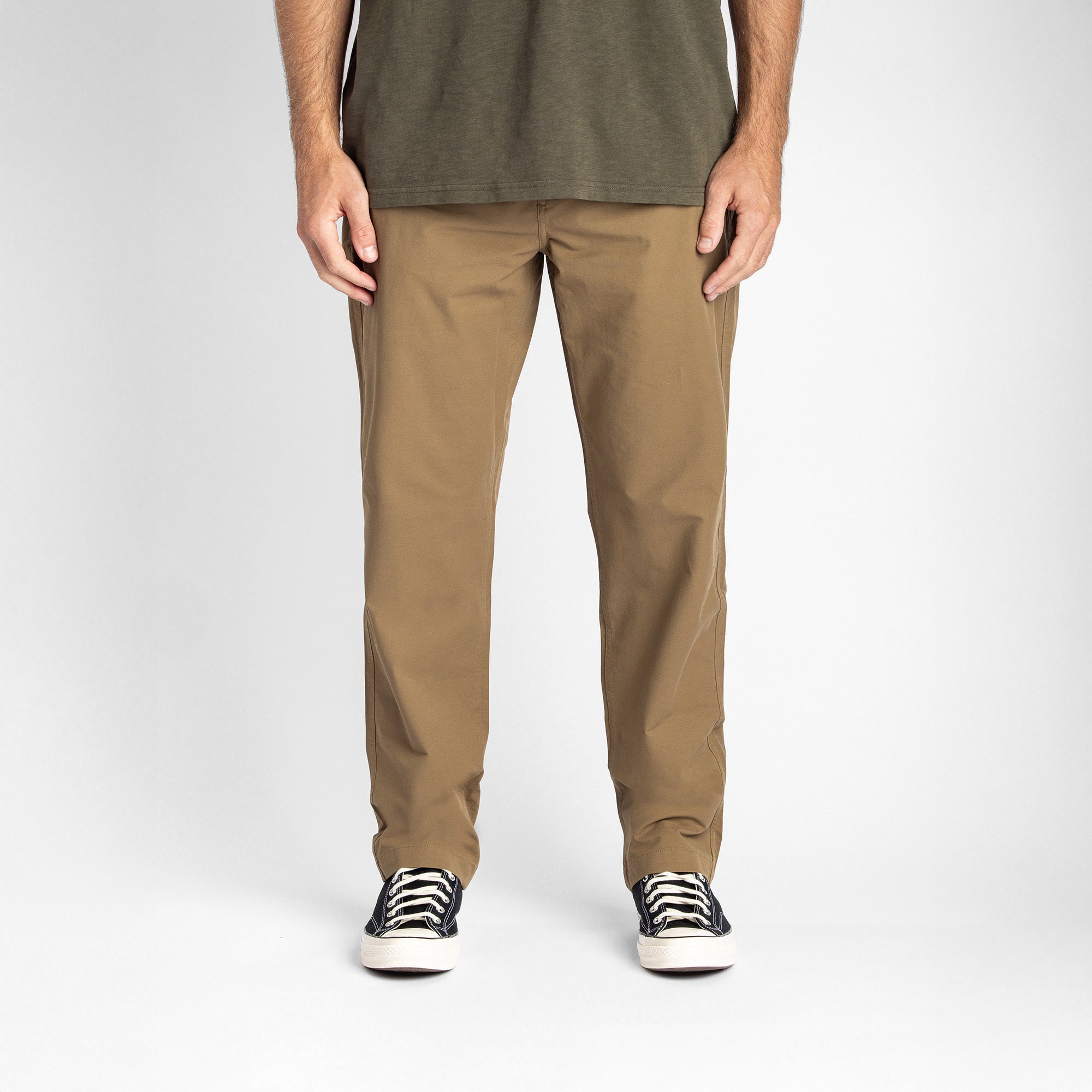 Person wearing Roark's Layover Pro Khaki pants, standing in a natural outdoor setting, ready for adventure.