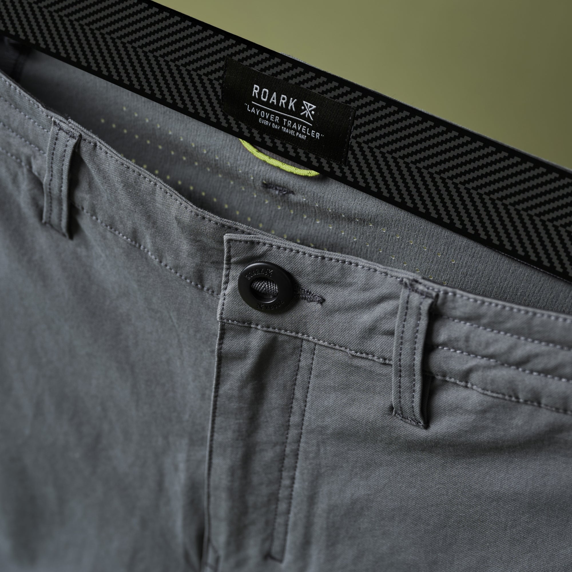 Man in action wearing Roark Layover Pro Pants, ideal for adventurous travel and outdoor activities