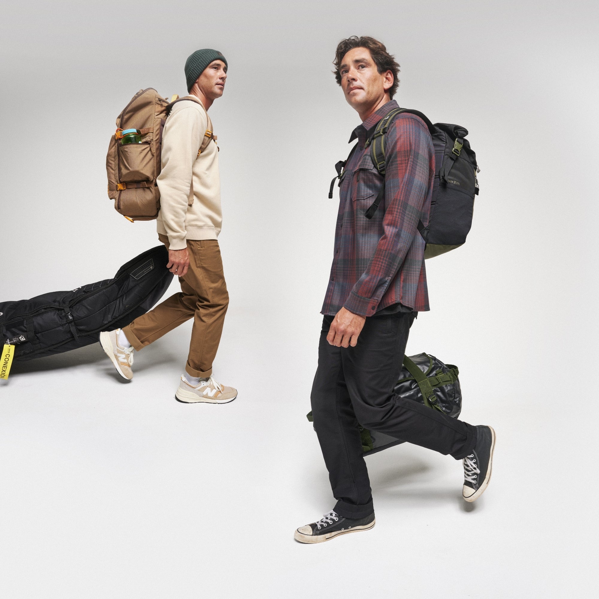 Assorted travel bags and luggage including a backpack, elegantly arranged for an adventure, capturing the spirit of Roark's travel-inspired gear.