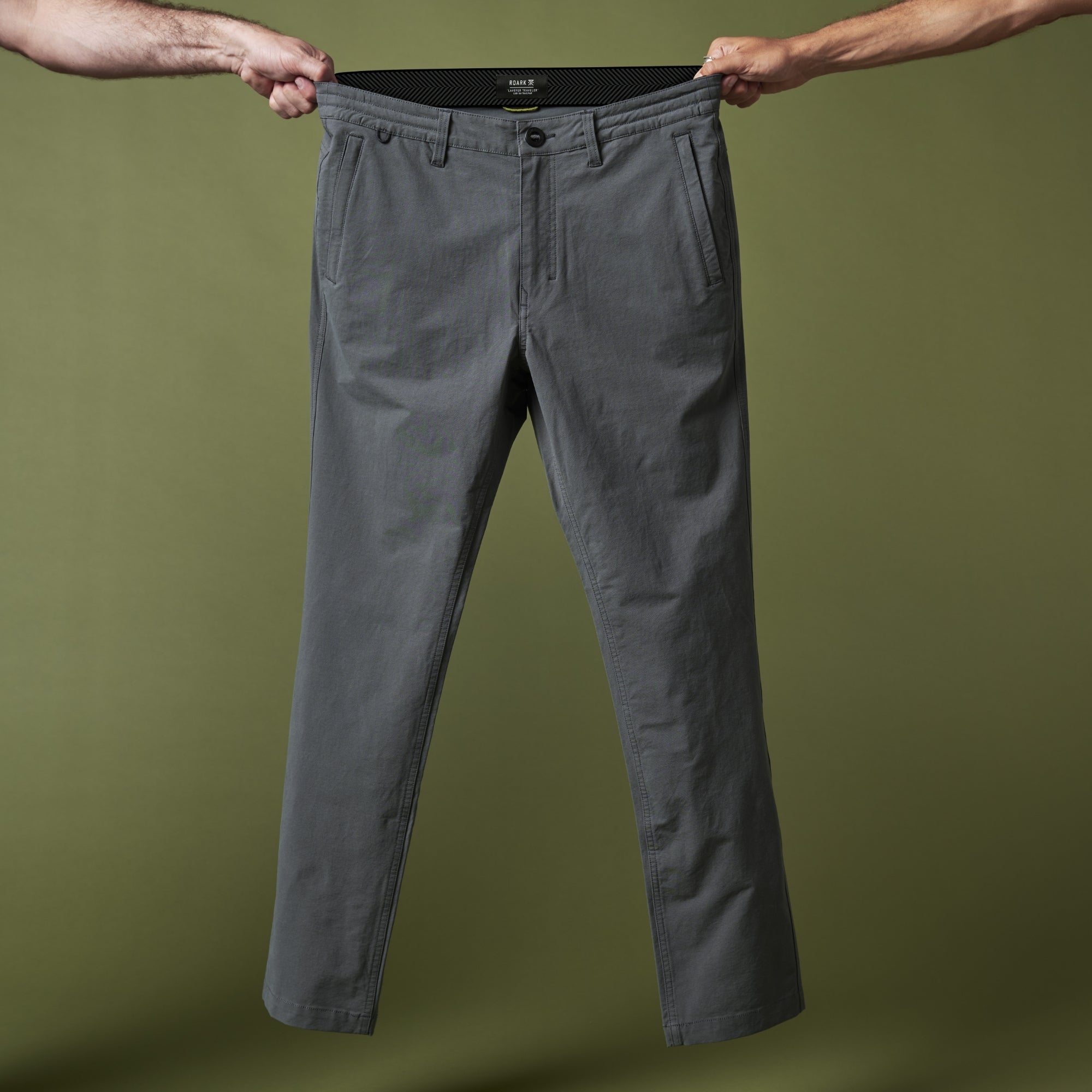 Man navigating through urban landscape wearing Roark Layover Pro Pants, showcasing versatility and style for travelers.