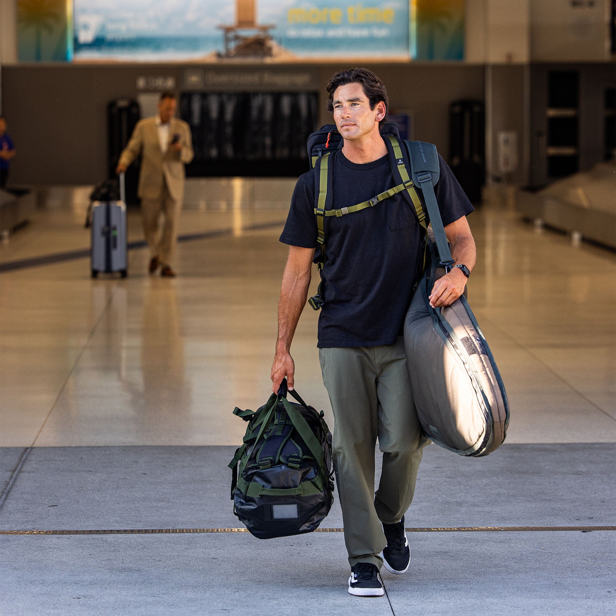 Travel essentials with Roark Layover Pro Pants featuring stylish yet durable footwear, modern backpack, and functional luggage for the avid adventurer.