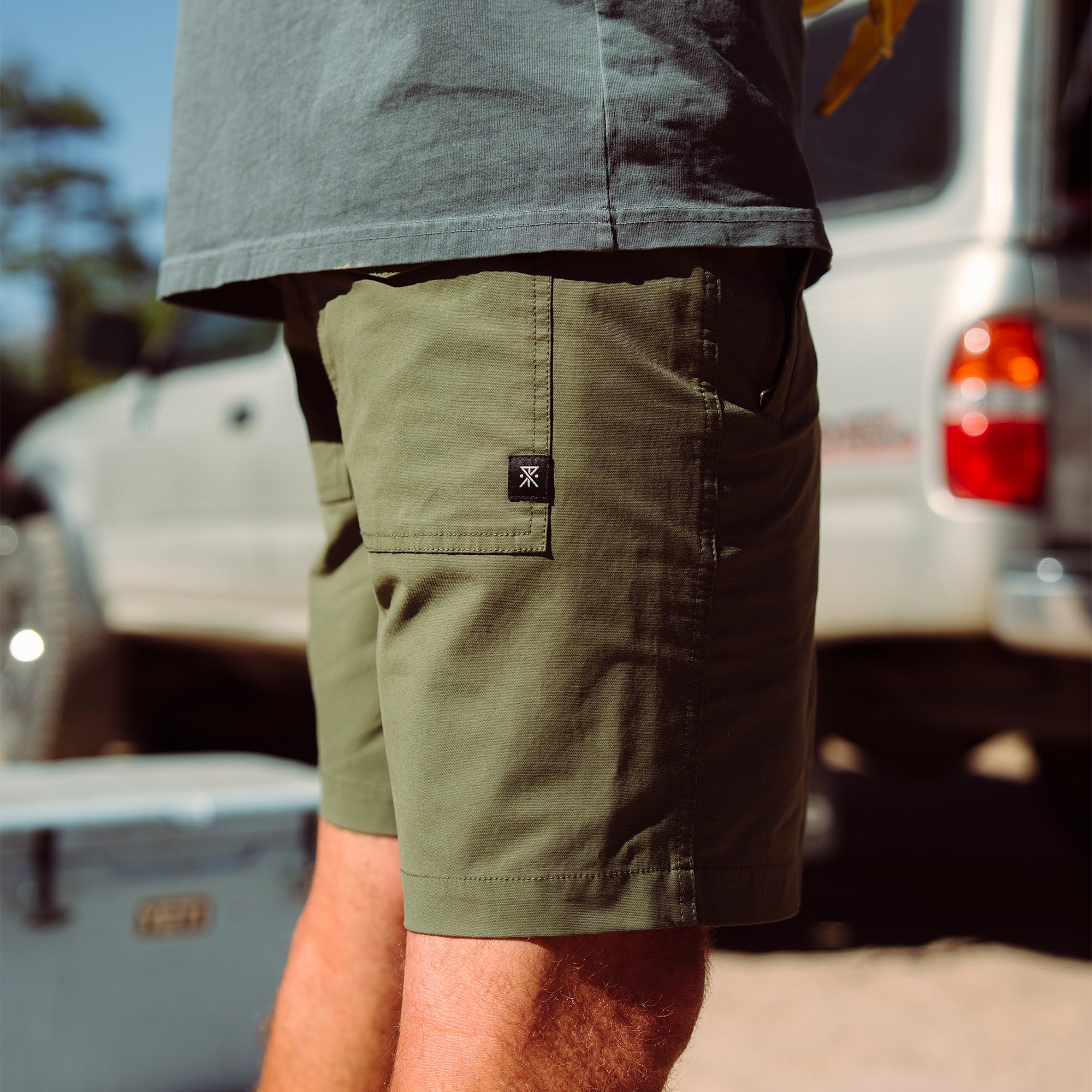 Comfortable Layover Pro shorts perfect for leisure and vacation, styled as Bermuda shorts on sandy beach setting, ideal for adventure and travel.