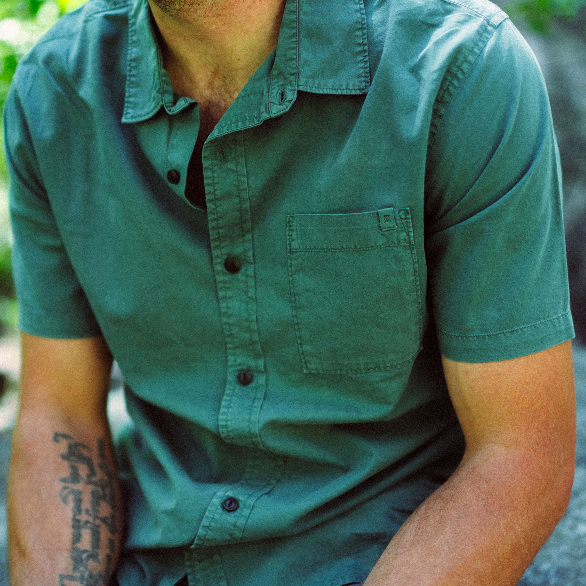 Close-up of a stylish Roark shirt featuring detailed sleeves, collar, and buttons, perfect for adventure and travel.