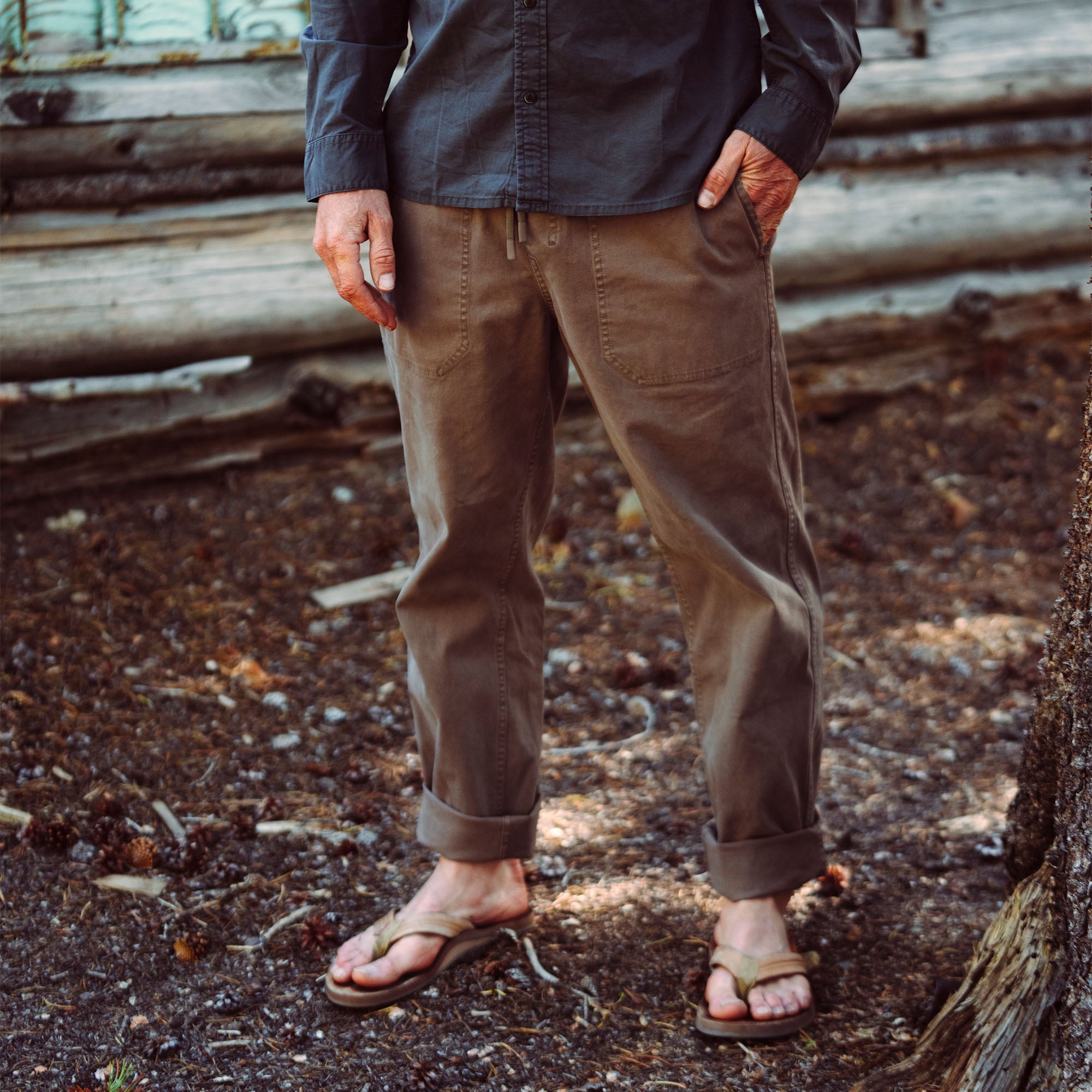 Stylish Made to Fade pants displayed on a rugged outdoor track made of leather, perfect for travel and adventure lovers.